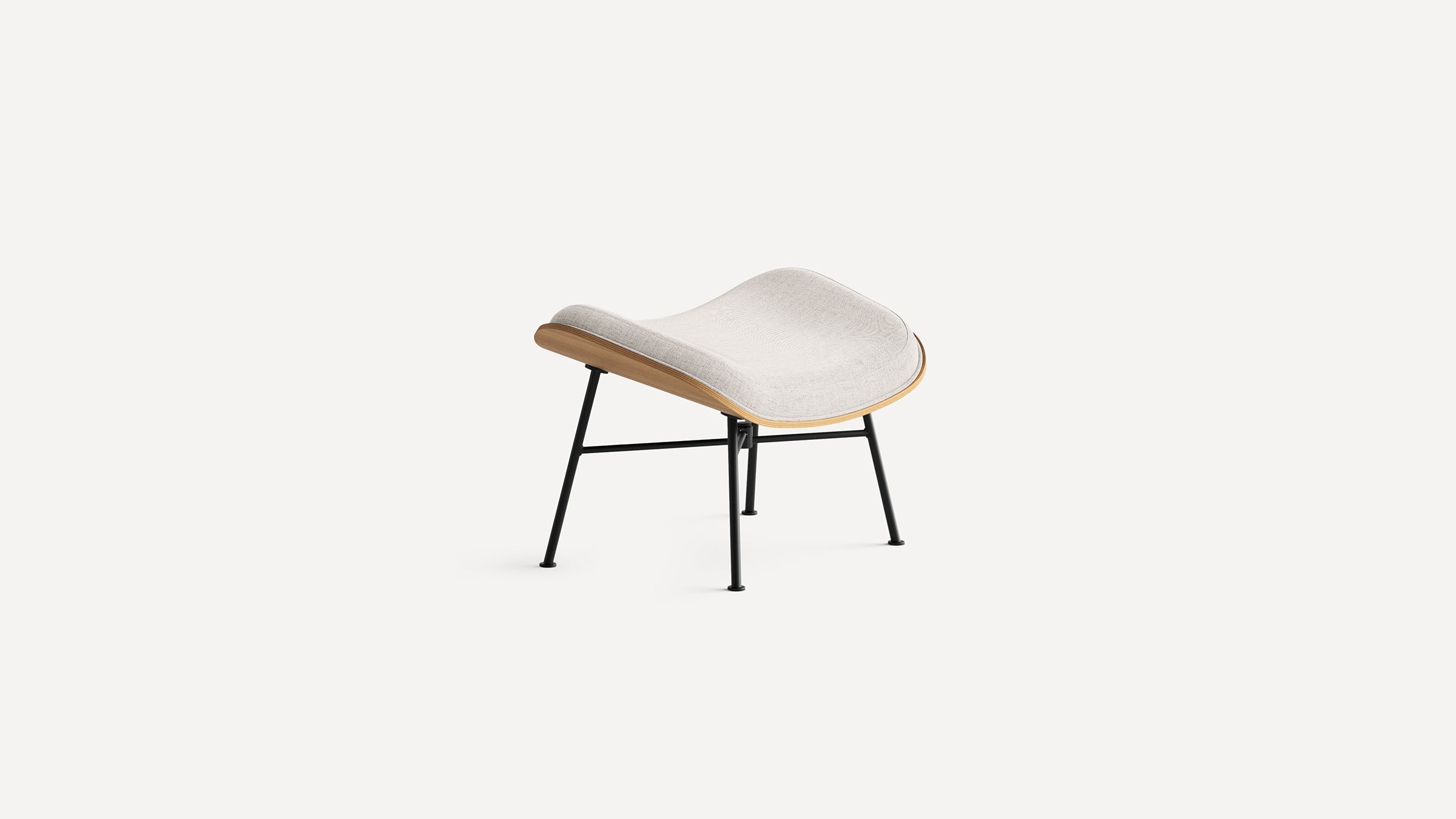 Modern ottoman with light beige curved cushion, wooden frame edge, and black metal legs on white background.