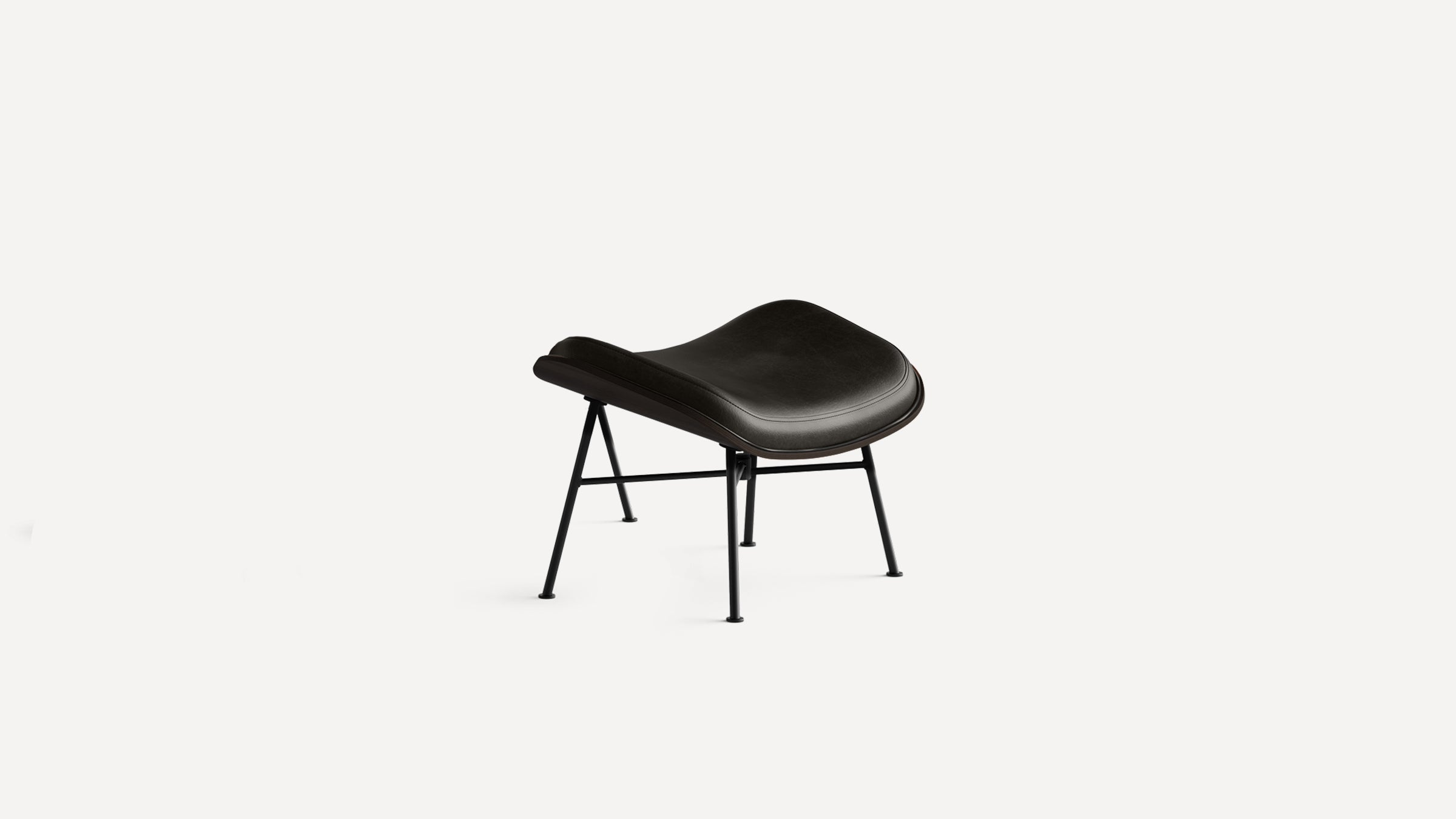 Modern black leather stool with curved seat and slender black metal legs, minimalist style.