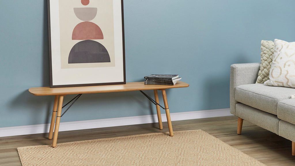 a modern living room with a gray sofa and a wooden coffee table