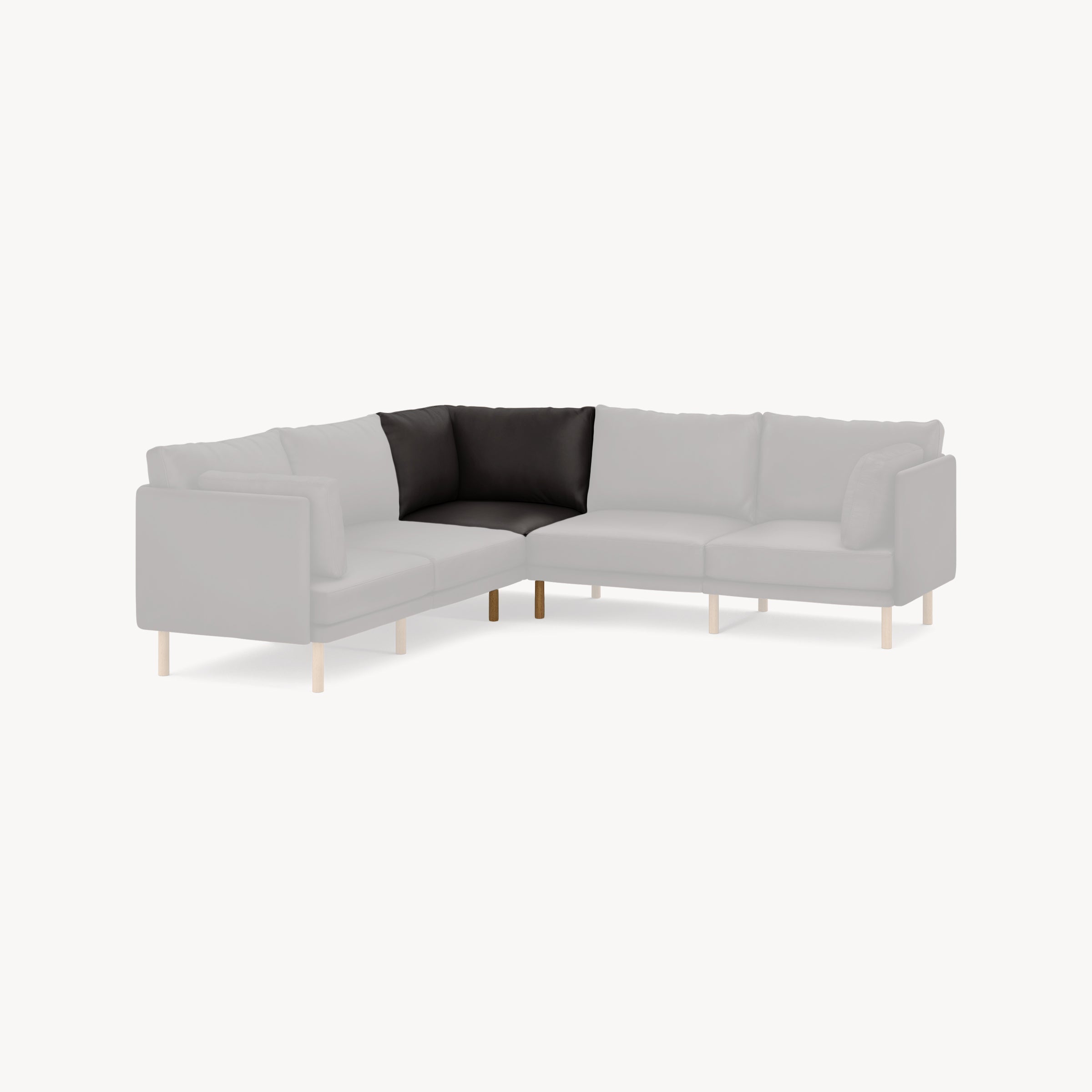 Corner seat cushion in black leather for gray sectional sofa with wooden legs, highlighting one corner piece.