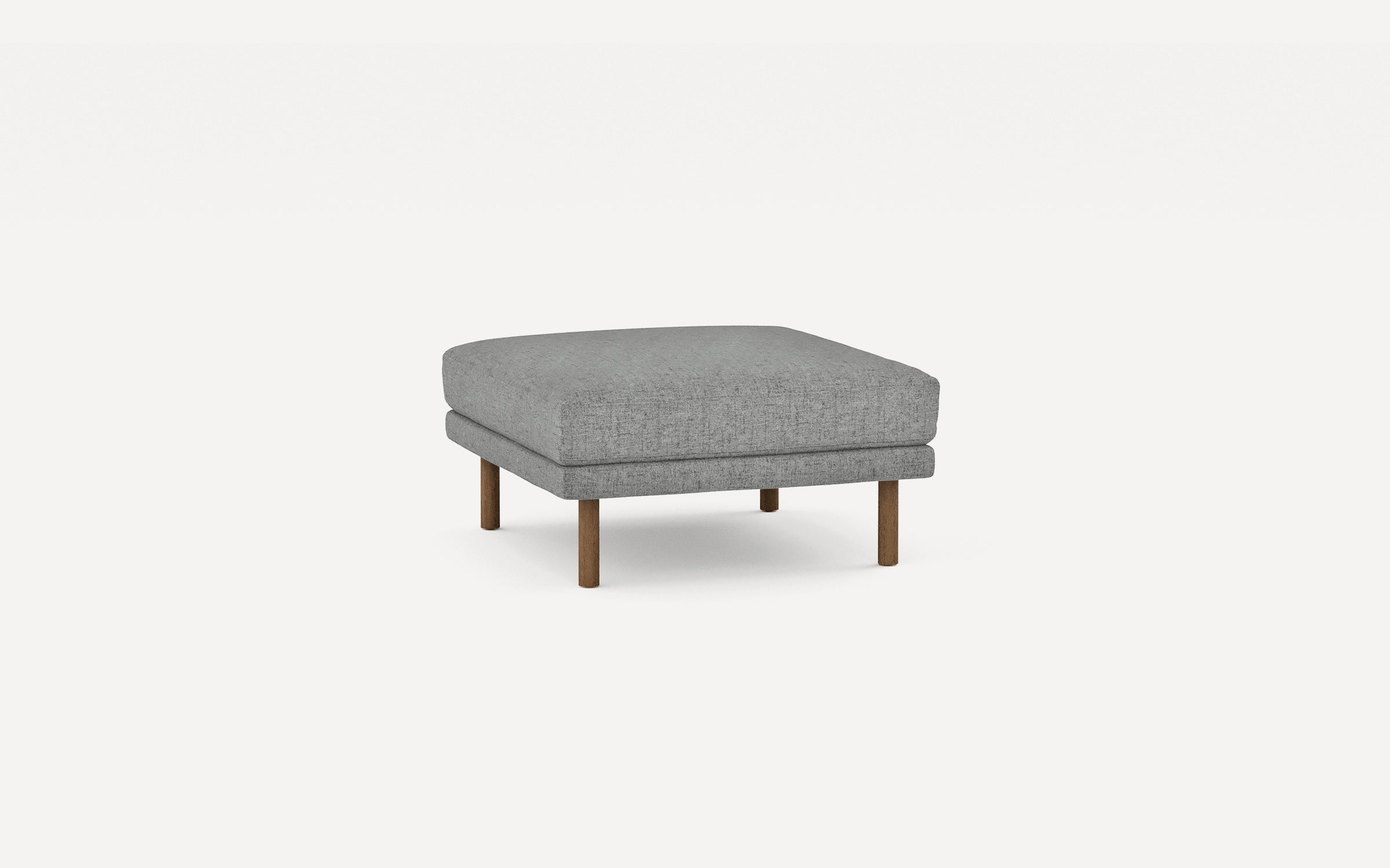 Square gray fabric ottoman with four wooden legs, featuring a cushioned top and minimalist design.