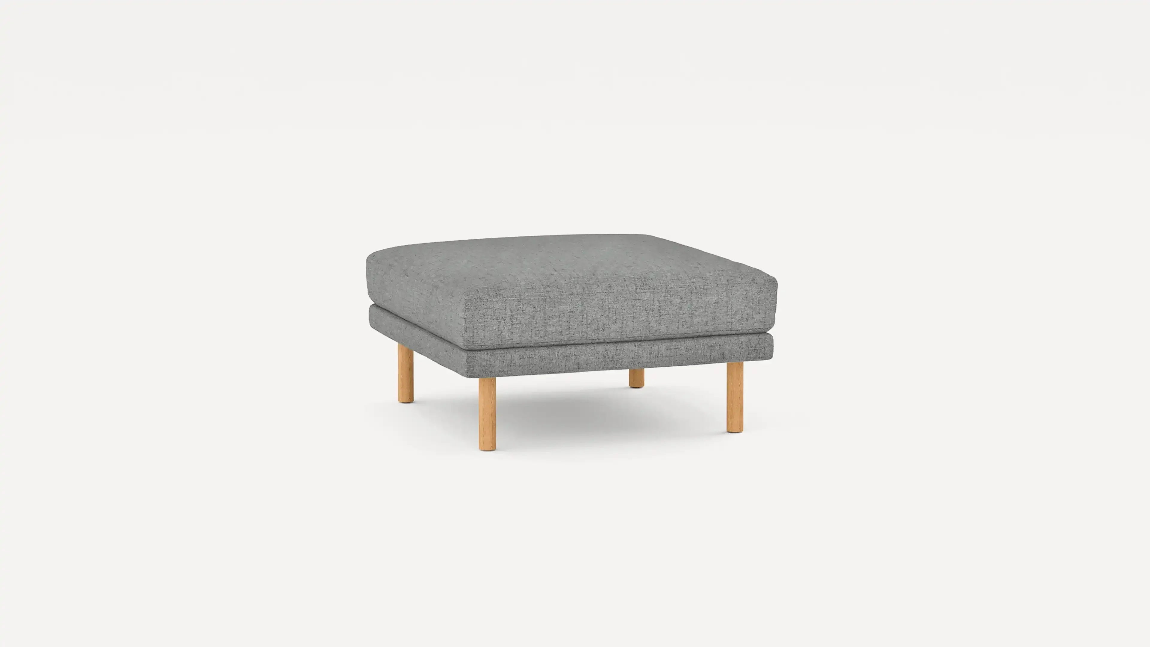modern gray upholstered ottoman with wooden legs and cushioned seat, isolated on a white background