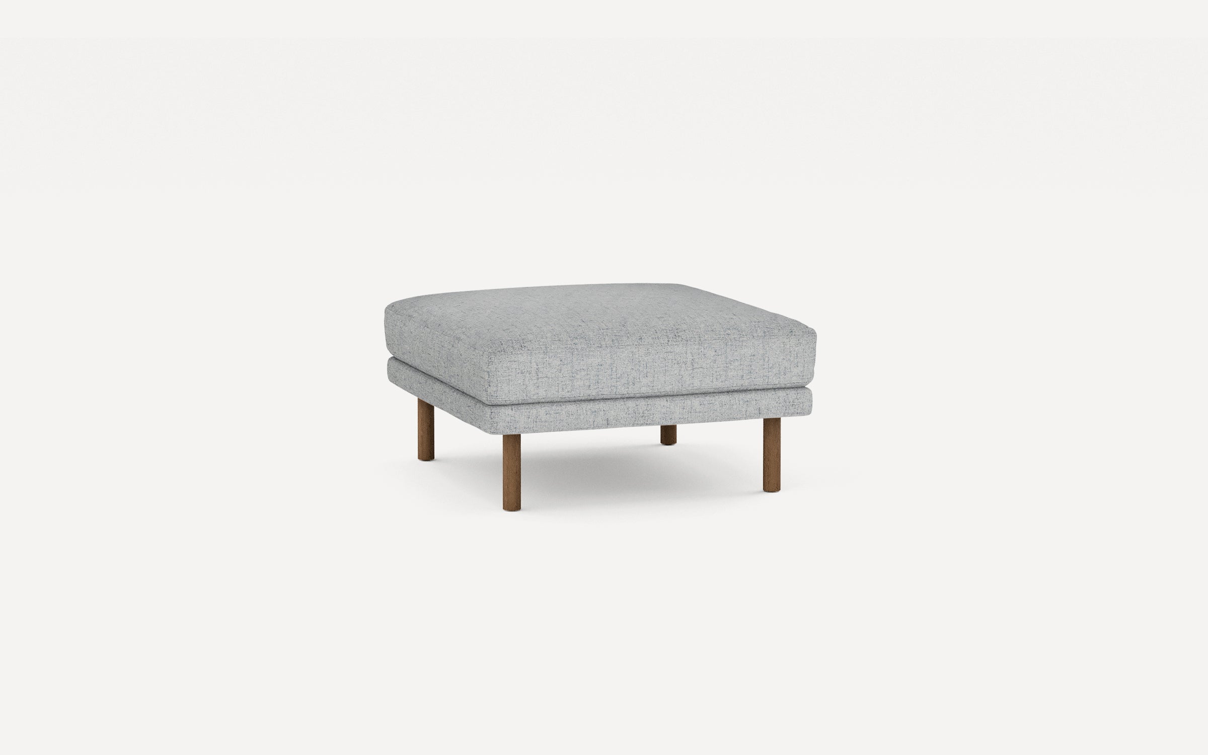 light gray upholstered ottoman with wooden legs and a square cushion on a white background