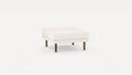 Square ottoman with white textured upholstery and four short wooden legs on a plain white background.