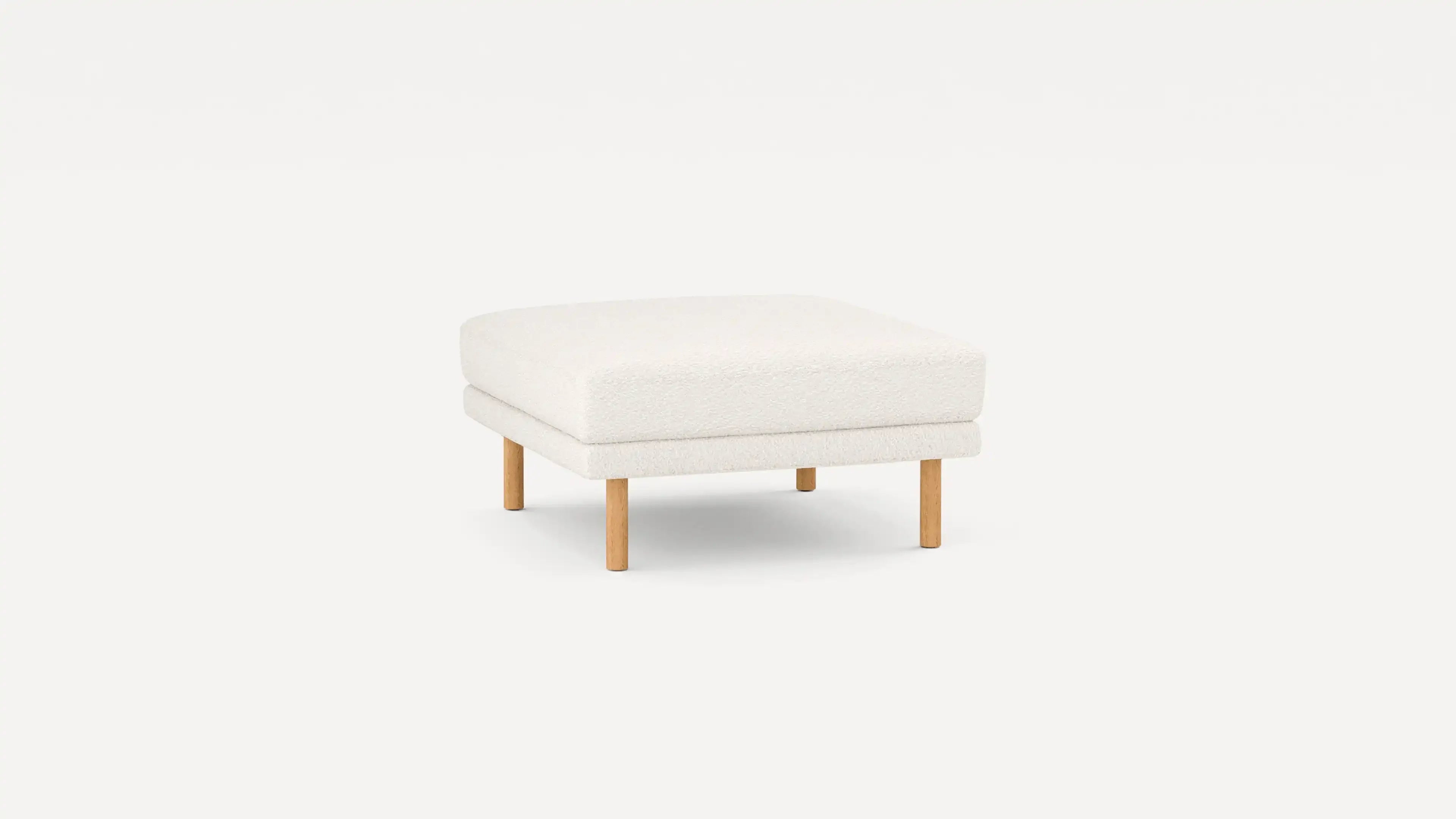 modern white upholstered ottoman with wooden legs and a cushioned cushion on a plain white background
