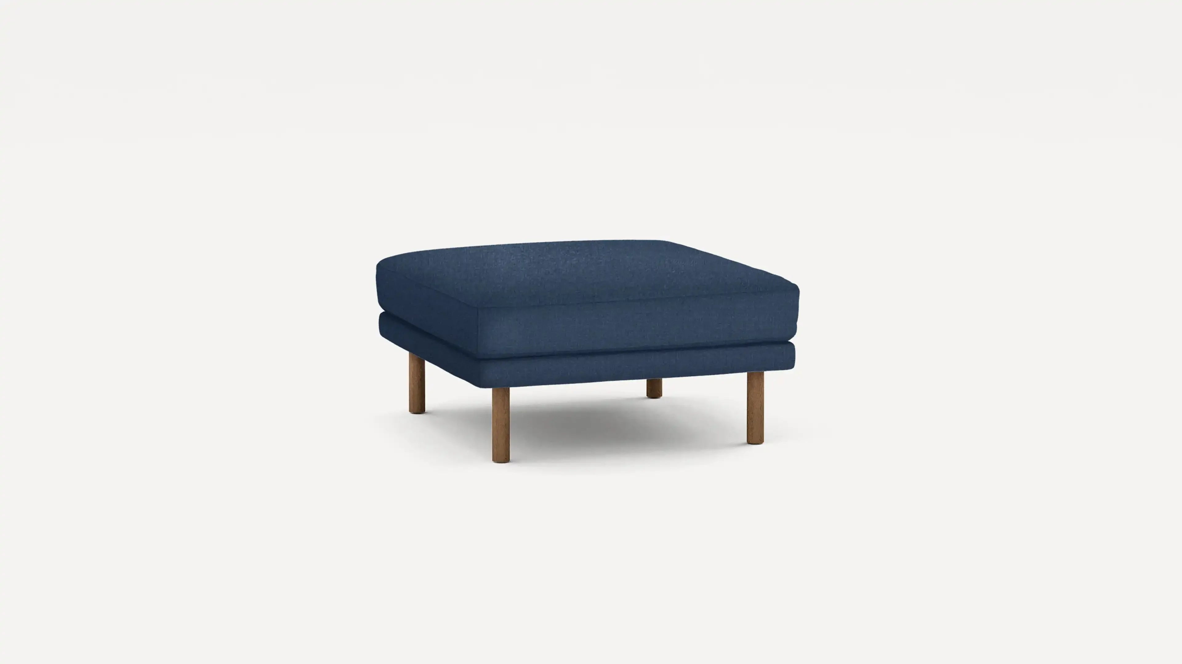 modern navy blue upholstered ottoman with wooden legs and a clean, minimalist design