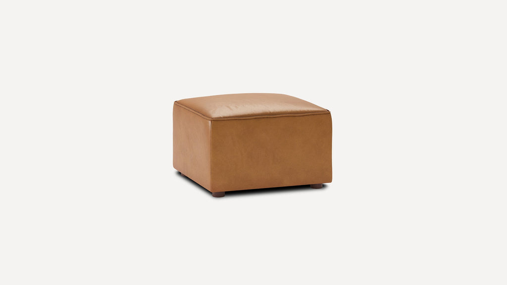 Square-shaped ottoman with smooth, tan leather upholstery and short wooden legs, set against a plain white background.