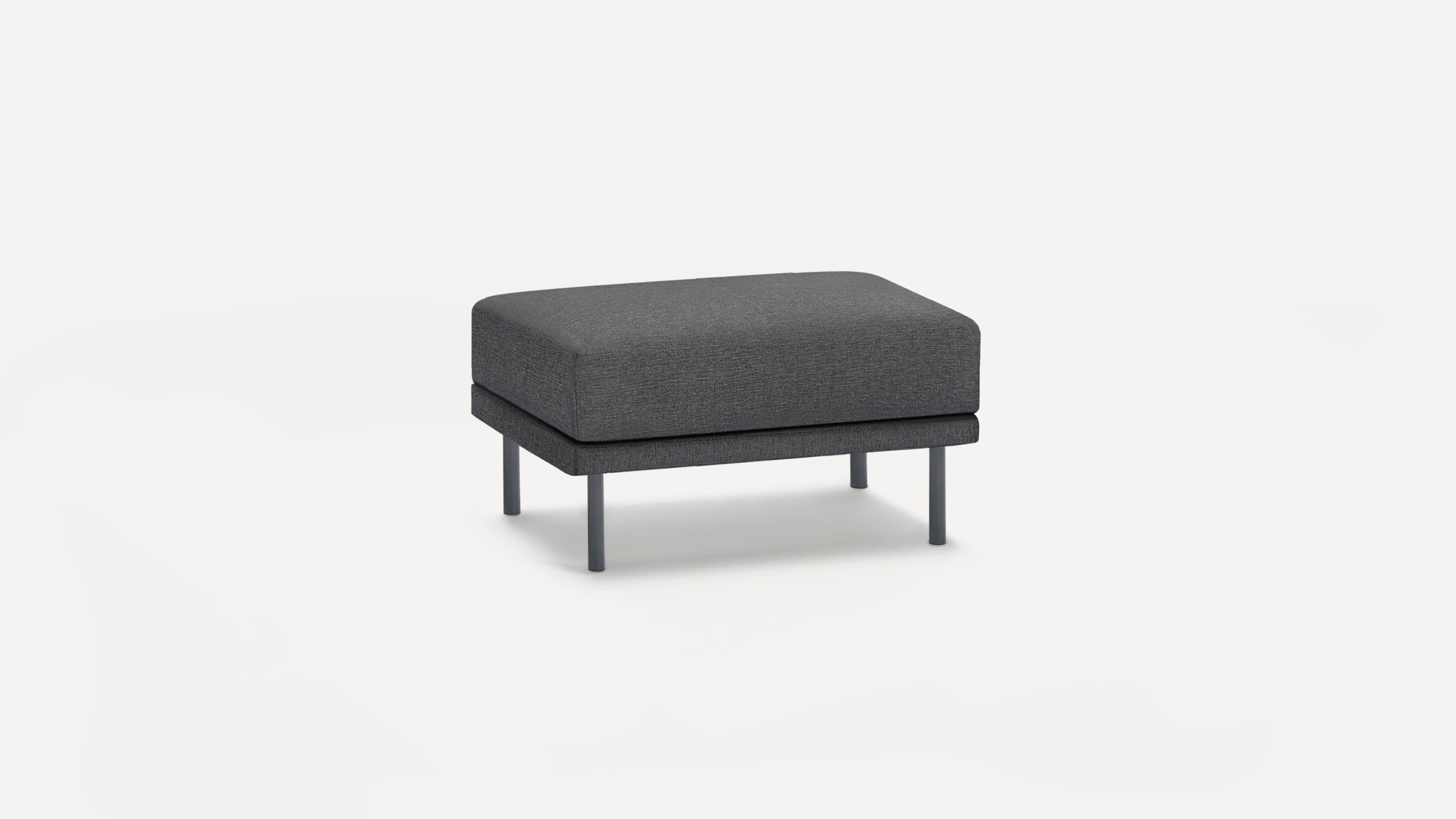 Dark gray modern rectangular ottoman with fabric upholstery and four metal legs on a white background.