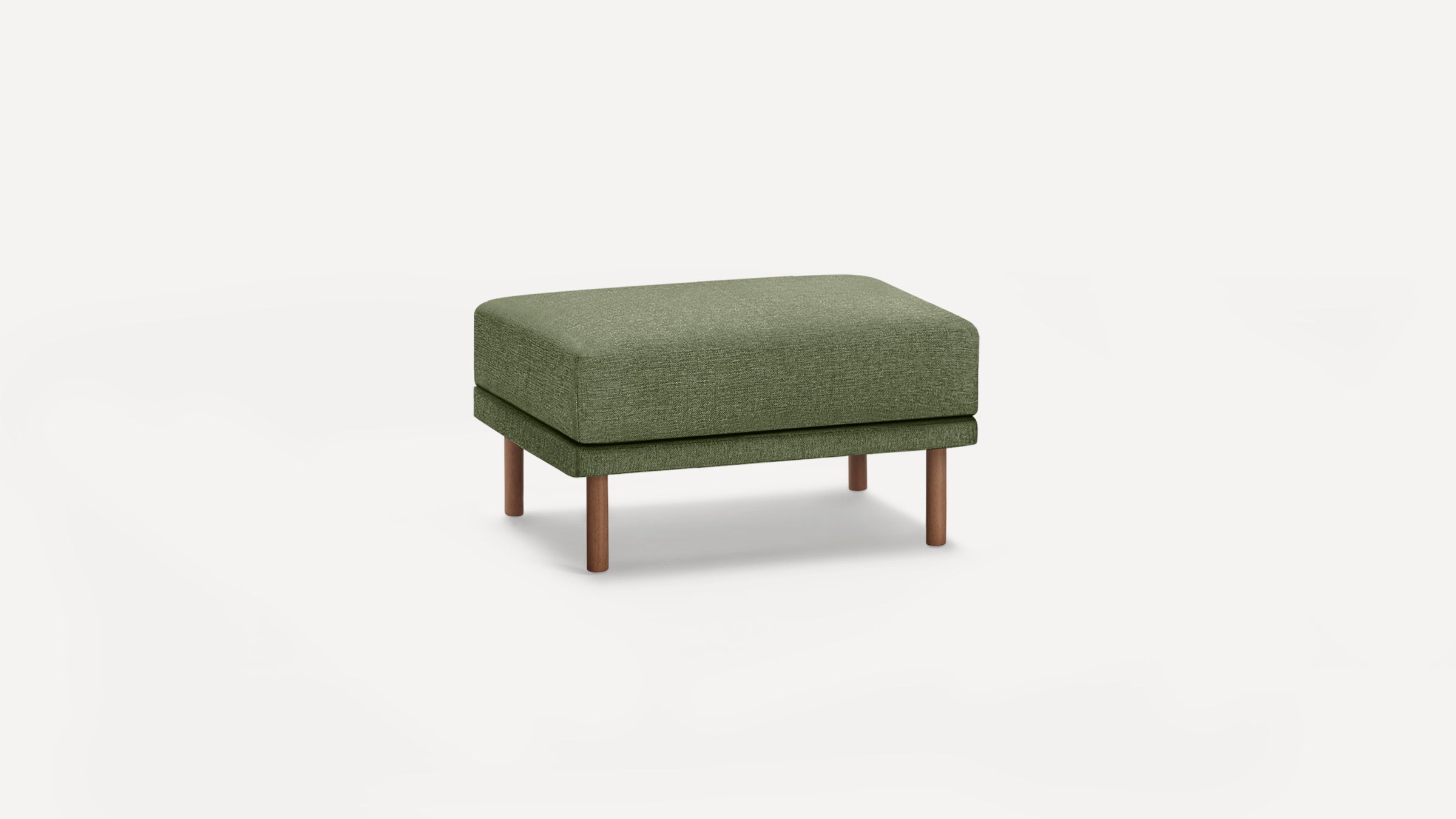 Green upholstered rectangular ottoman with wooden legs standing on a plain white background.