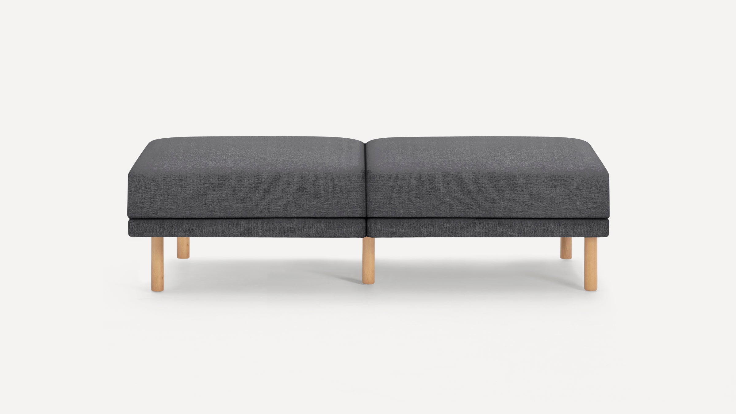 Modern rectangular dark gray fabric bench with light wooden legs, designed for seating or footrest.