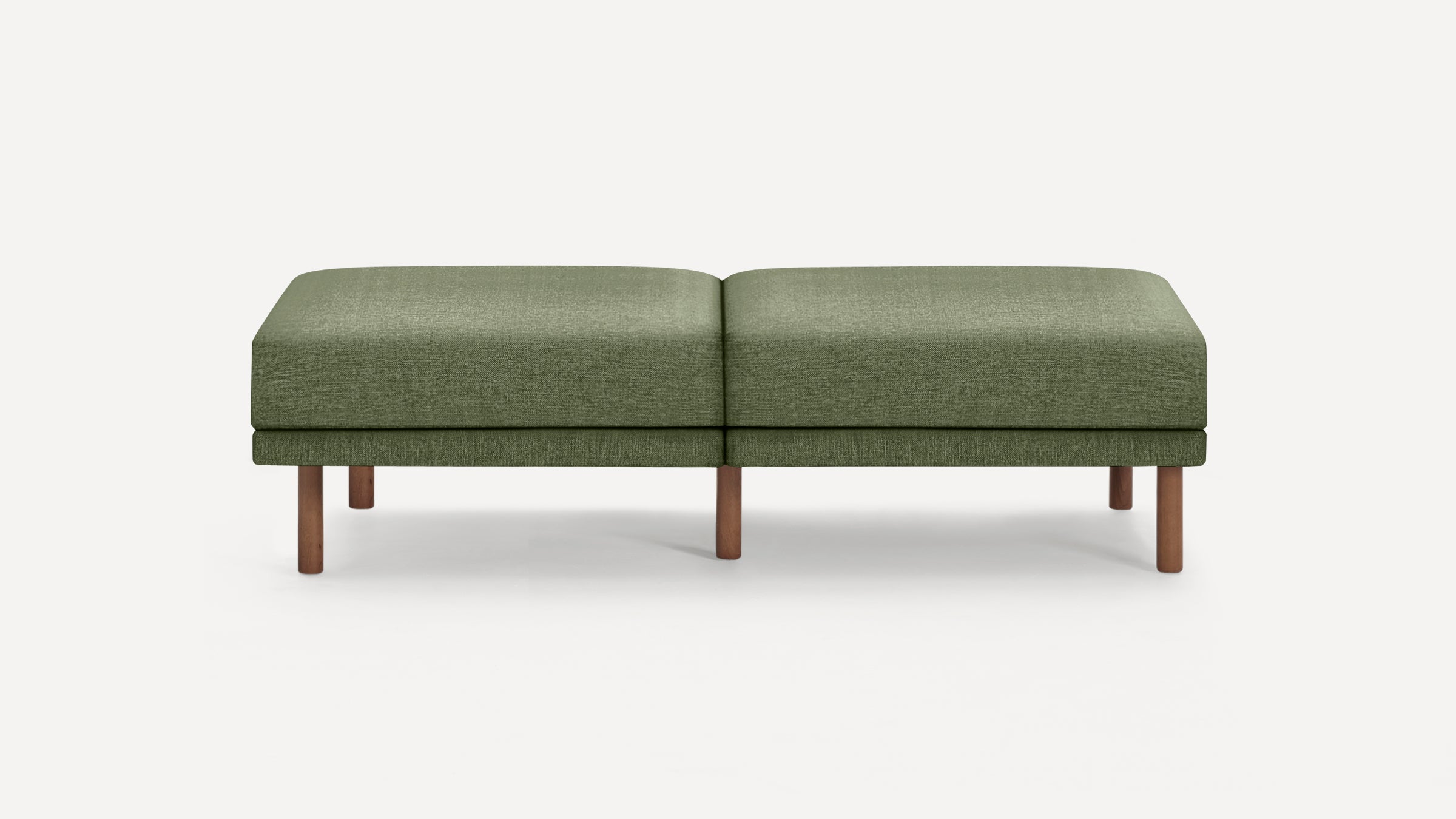 Green upholstered rectangular bench with rounded edges and wooden legs, set against a plain white background.