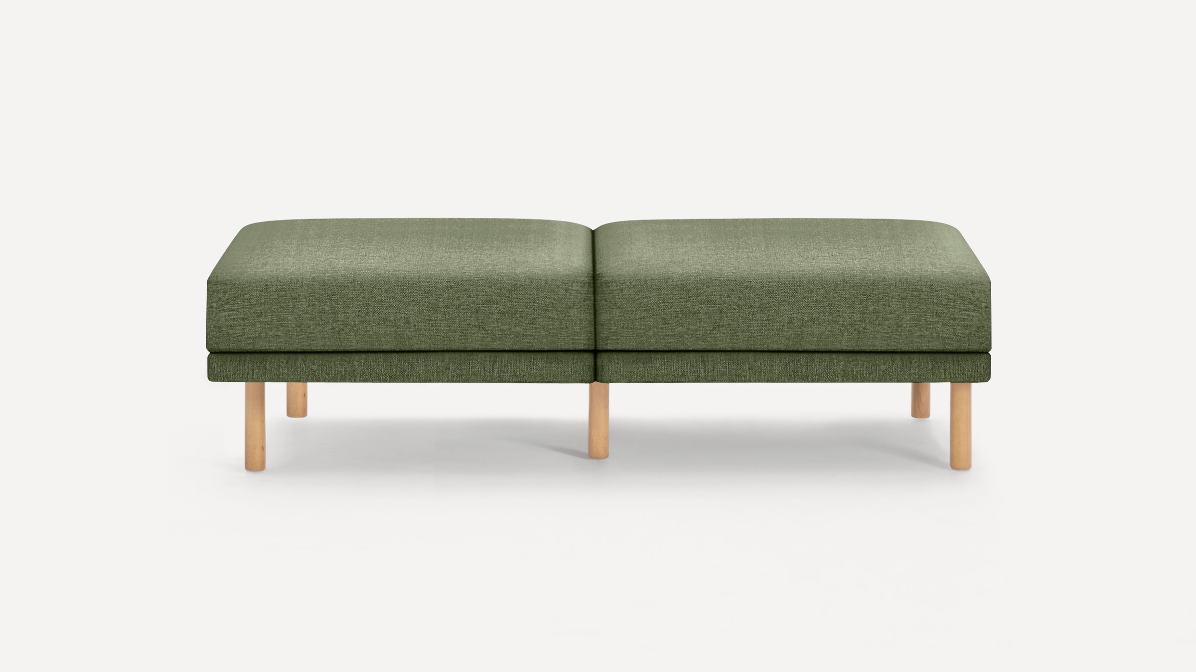 Green fabric upholstered rectangular bench with wooden legs on a white background.