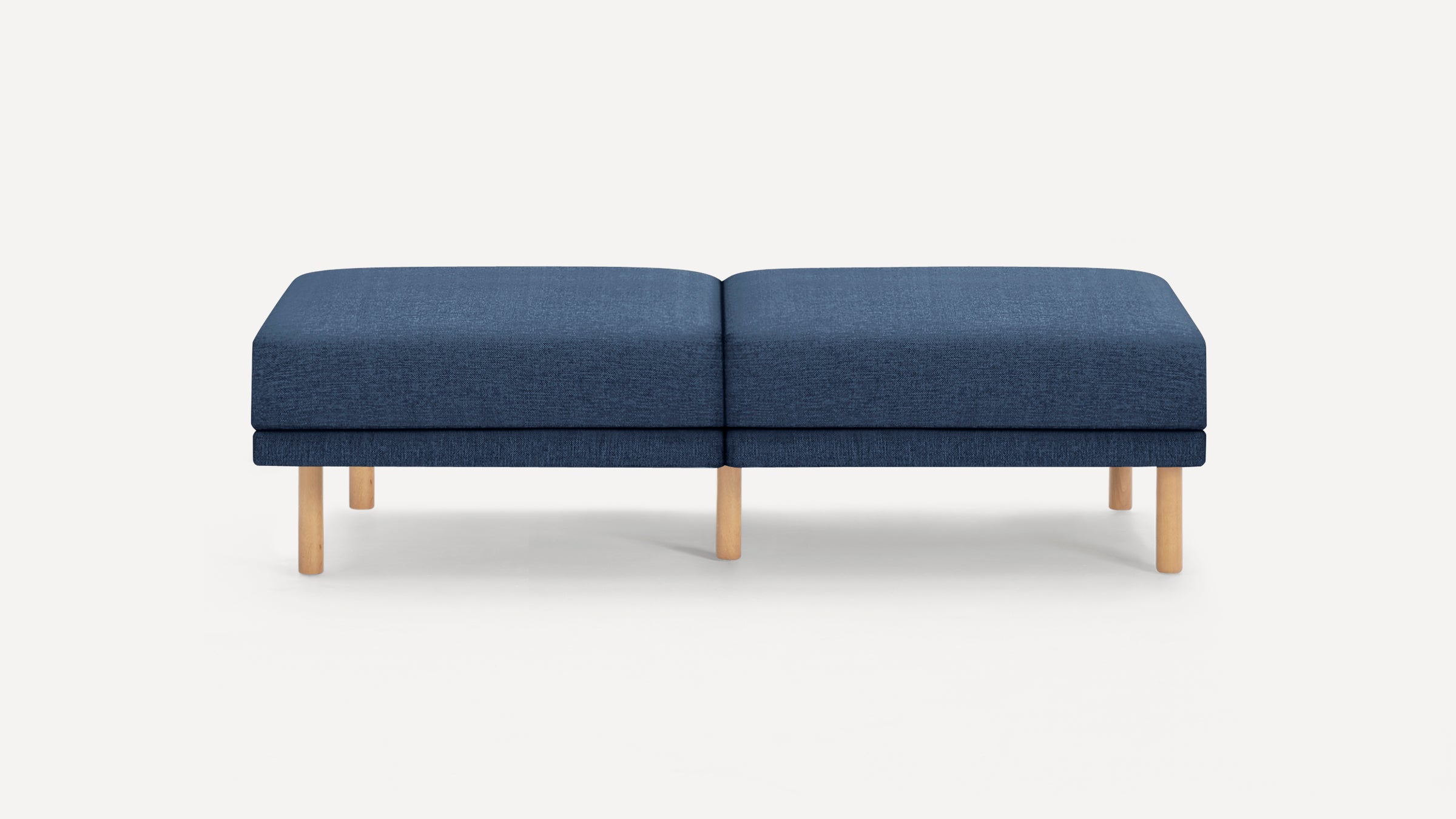 Modern rectangular navy blue upholstered bench with wooden legs against a white background.