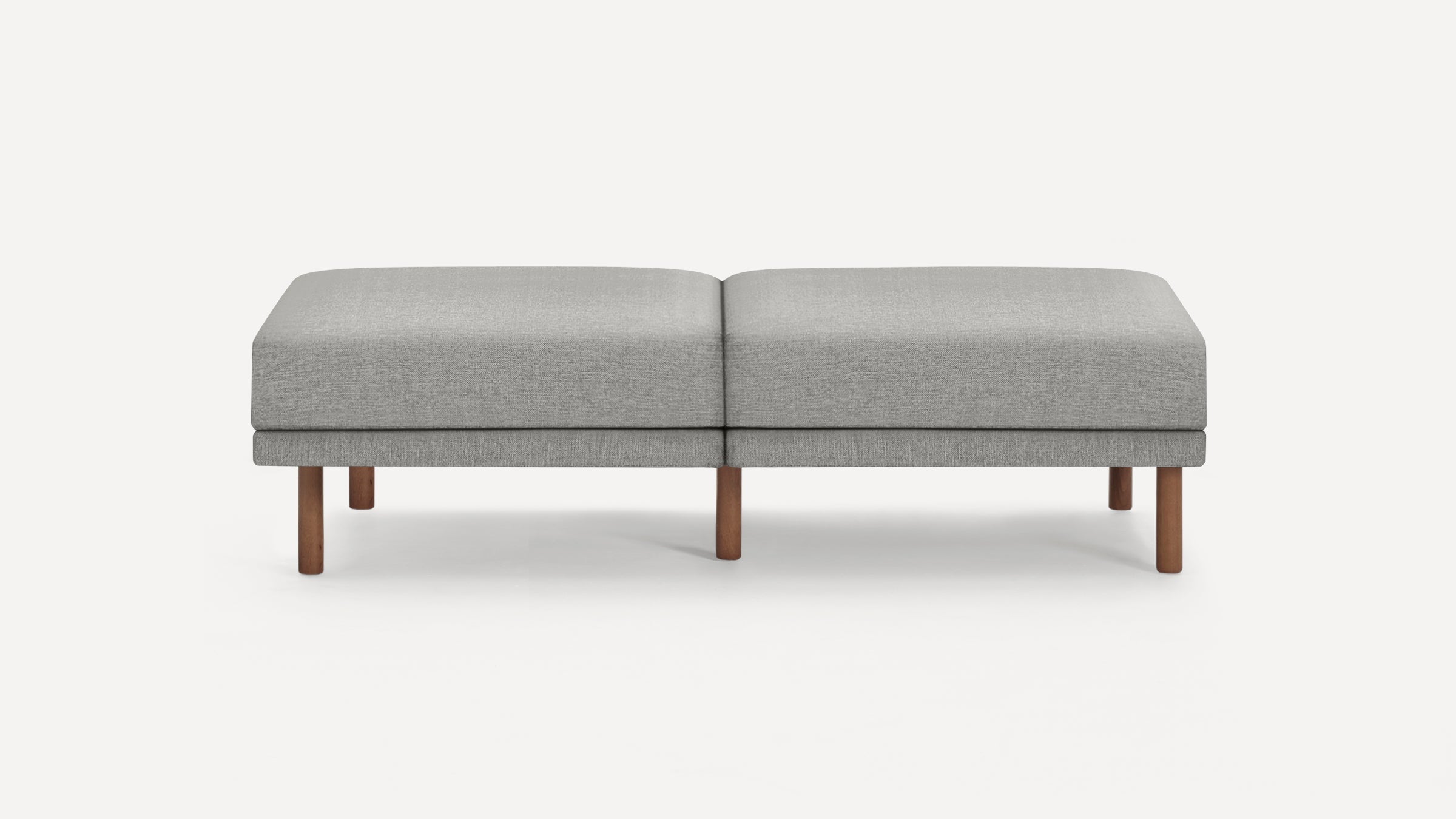 Modern rectangular gray fabric ottoman bench with wooden cylindrical legs, featuring a clean, minimalist design.