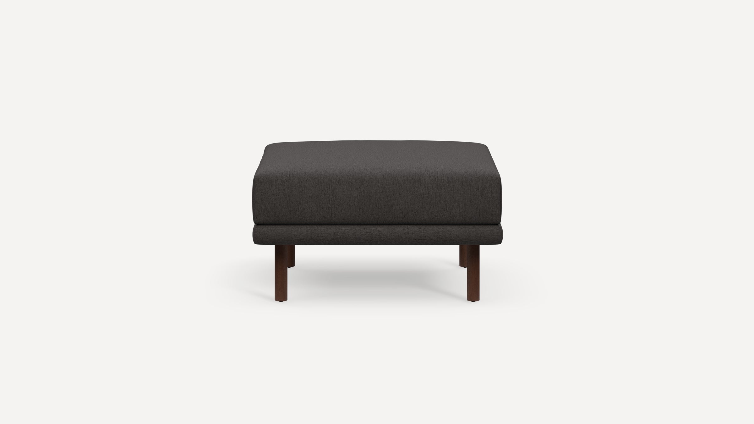 Front view of a modern dark gray square ottoman with wooden legs on a white background.