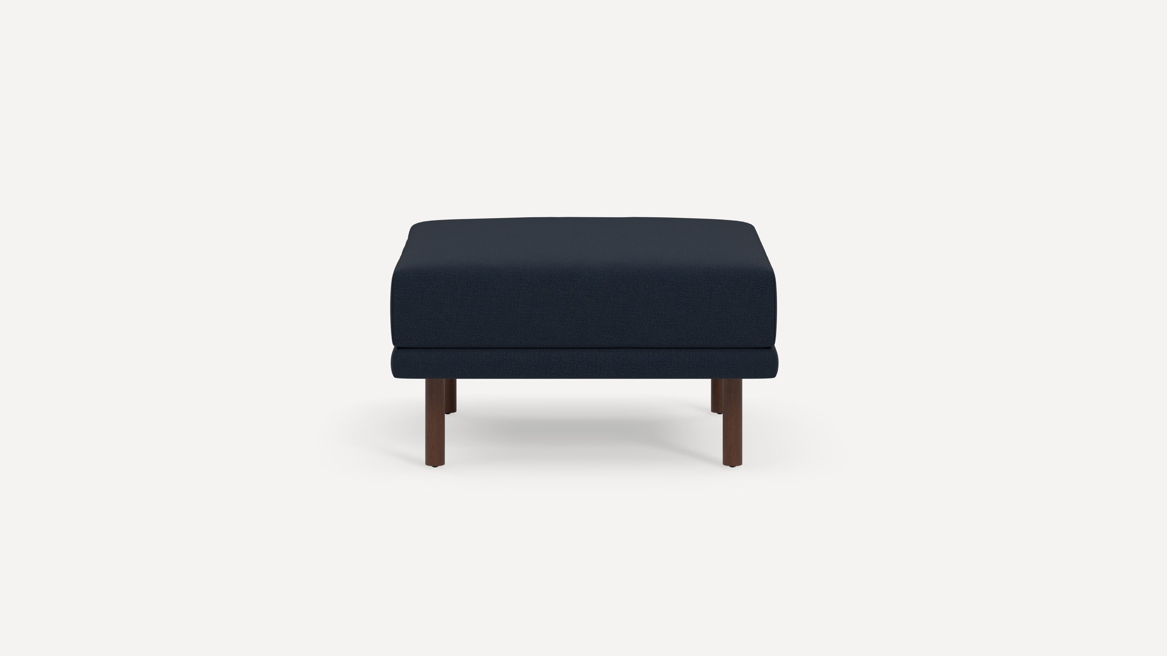 Square navy blue upholstered ottoman with simple wooden legs, shown against a plain white background.