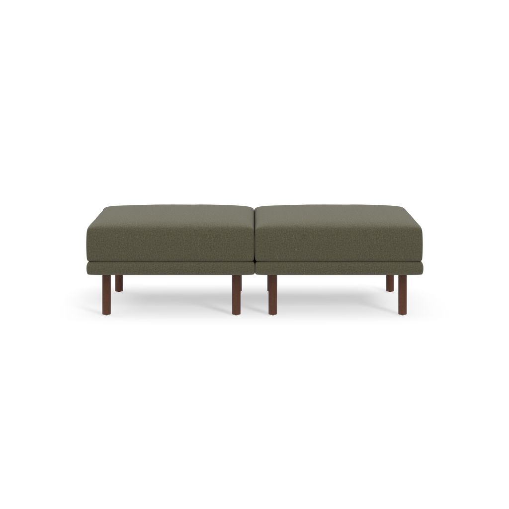 Two square Moss green upholstered cushions with brown wooden legs, arranged side by side on a black background.