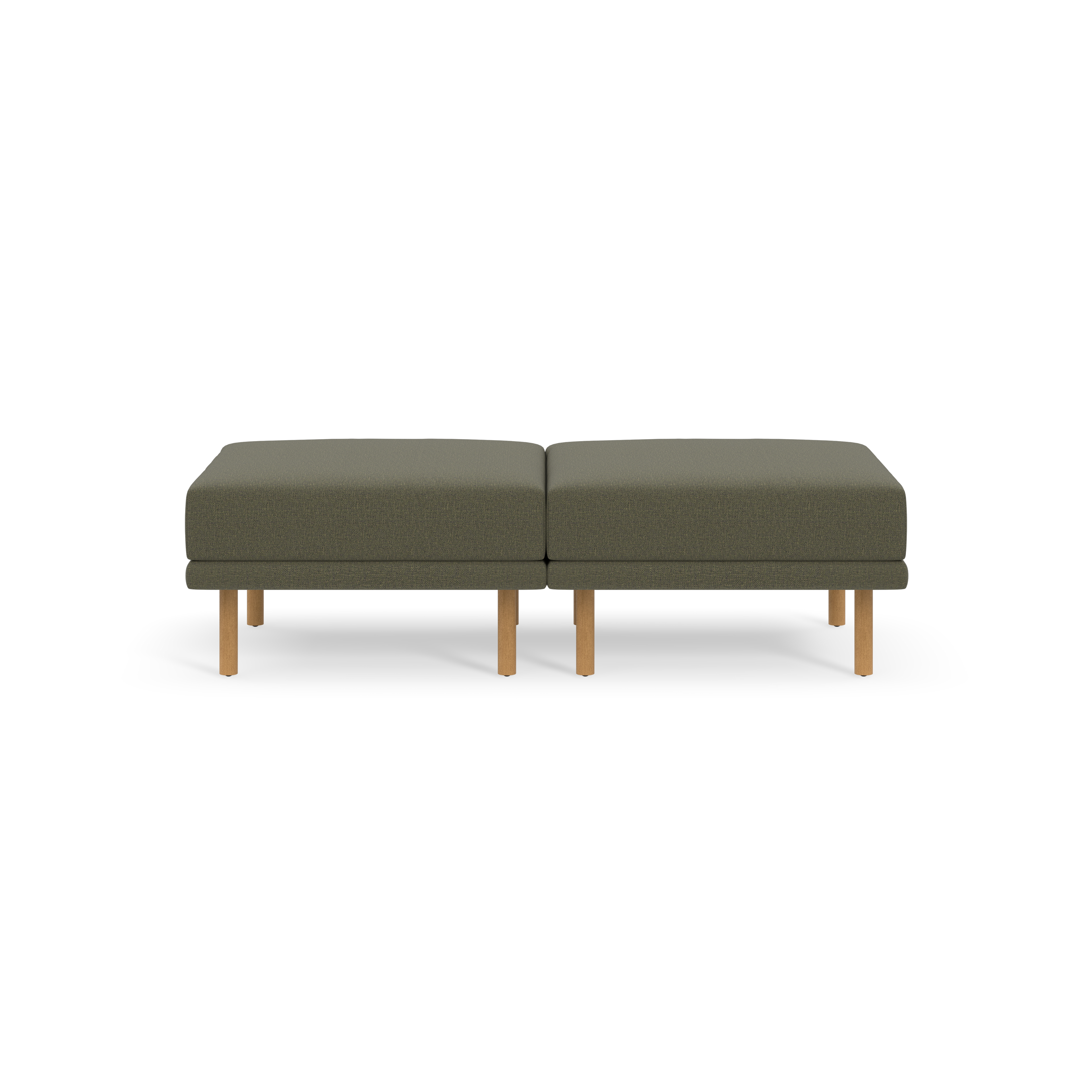 Two gray ottoman cushions with wooden legs, placed side by side on a black background.