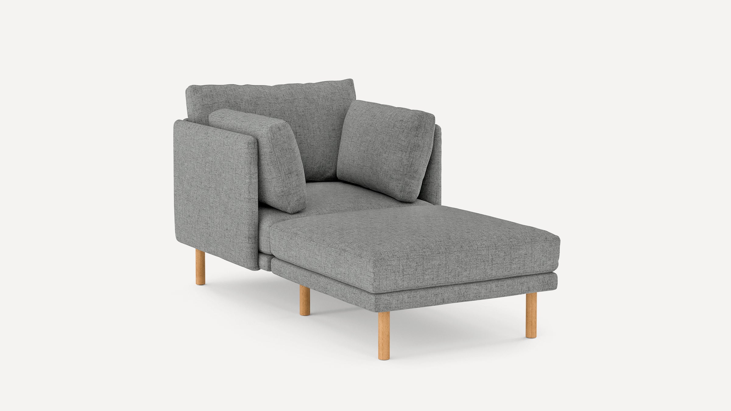 Modern chaise lounge chair in gray fabric with wooden legs and three matching cushions, angled view on white background.