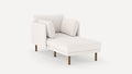 Modern white chaise lounge with plush cushions and wooden legs, featuring a textured fabric upholstery.