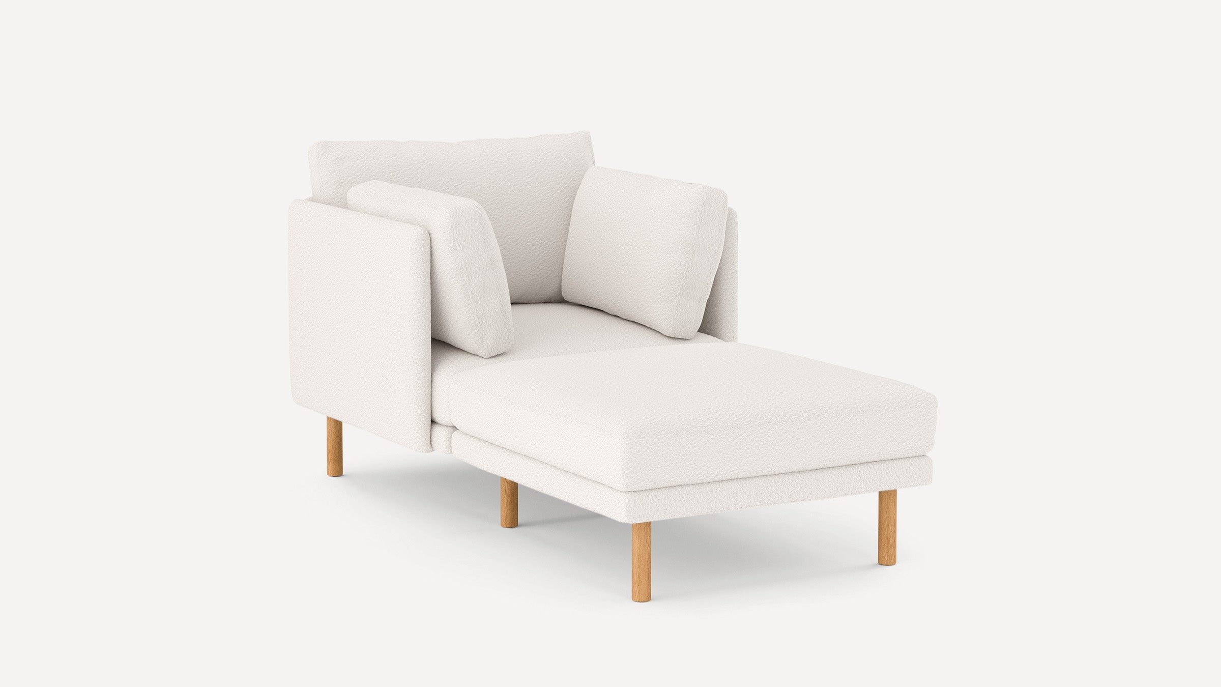 Modern white chaise lounge chair with soft textured fabric, two cushions, and light wooden legs on a plain background.