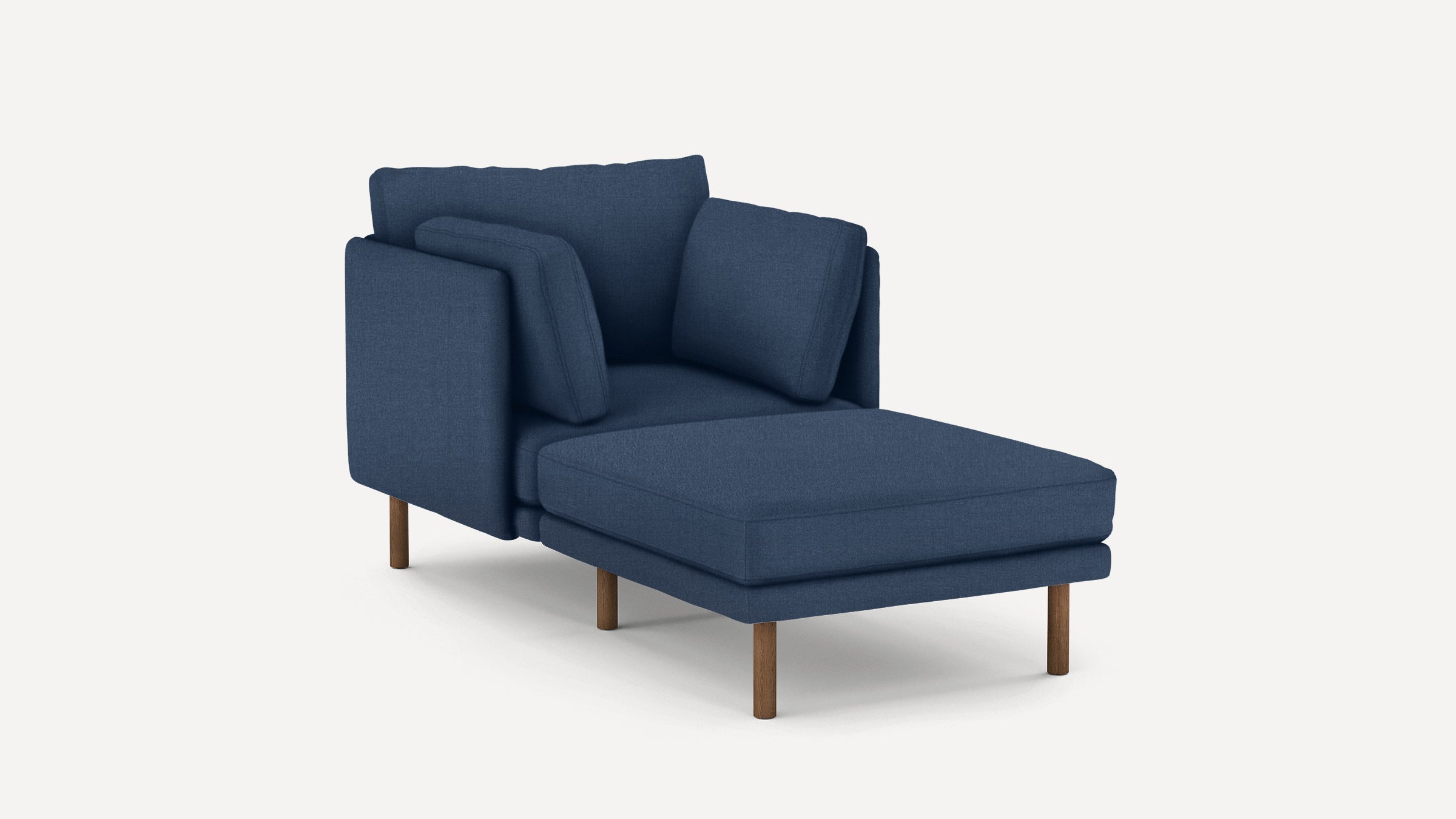 Modern navy blue chaise lounge with supporting cushions and wooden tapered legs on a light background.