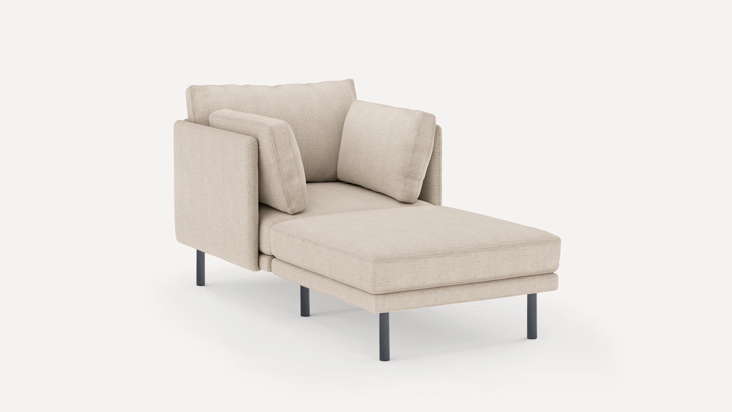 Beige upholstered chaise lounge with cushioned back and side armrests, supported by slim black metal legs.