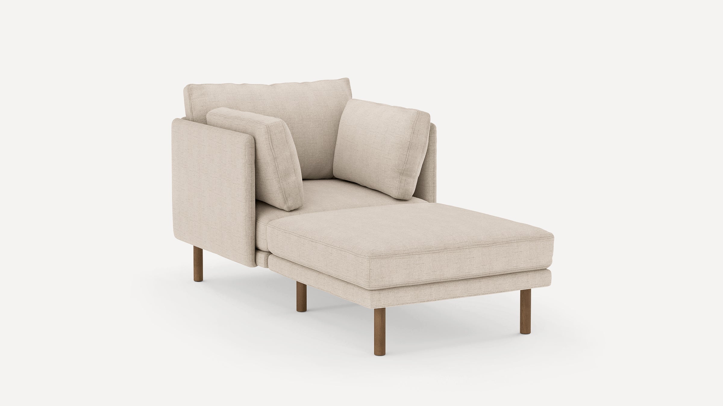 Beige upholstered modern chaise lounge with wooden legs, featuring three matching cushions and a minimalist design.