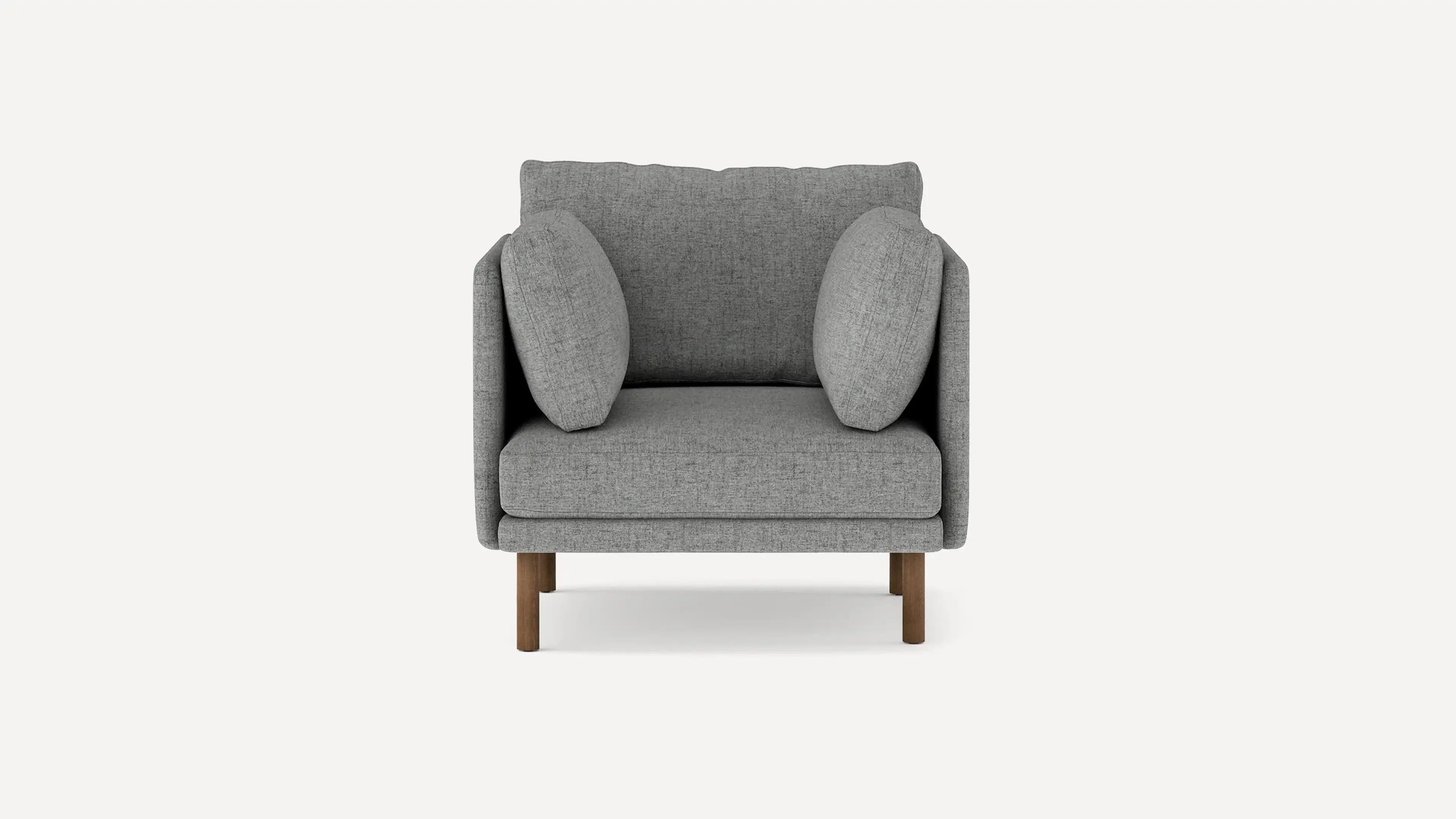 Gray fabric armchair with two rounded side cushions, wooden legs, and a cushioned backrest, shown against a plain background.