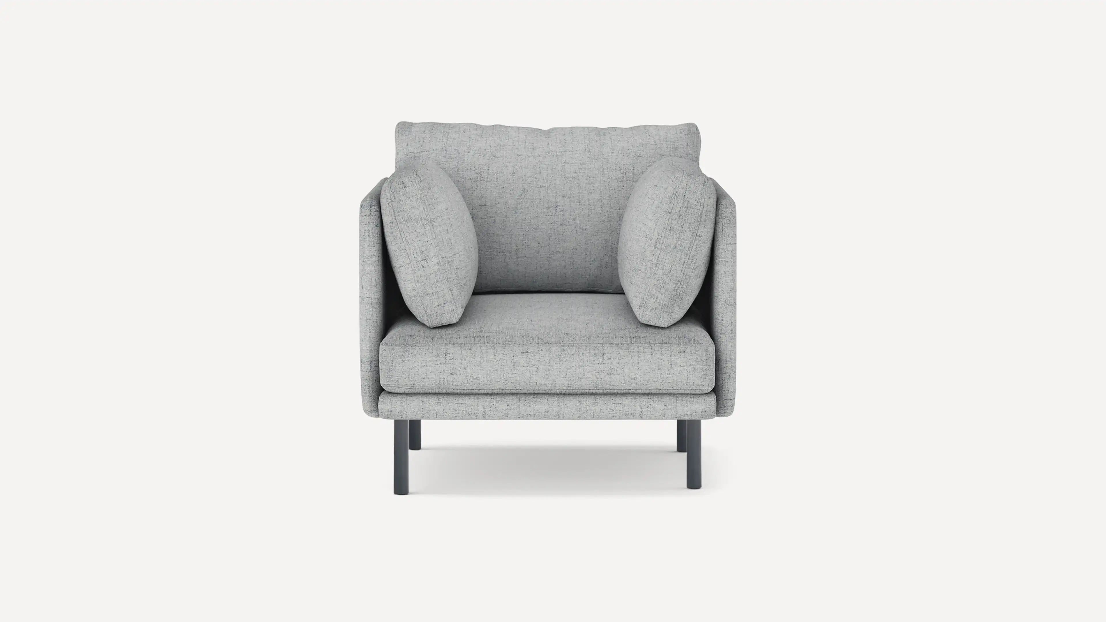 Modern armchair with light grey textured upholstery, two side cushions, and black metal legs, shown from front.