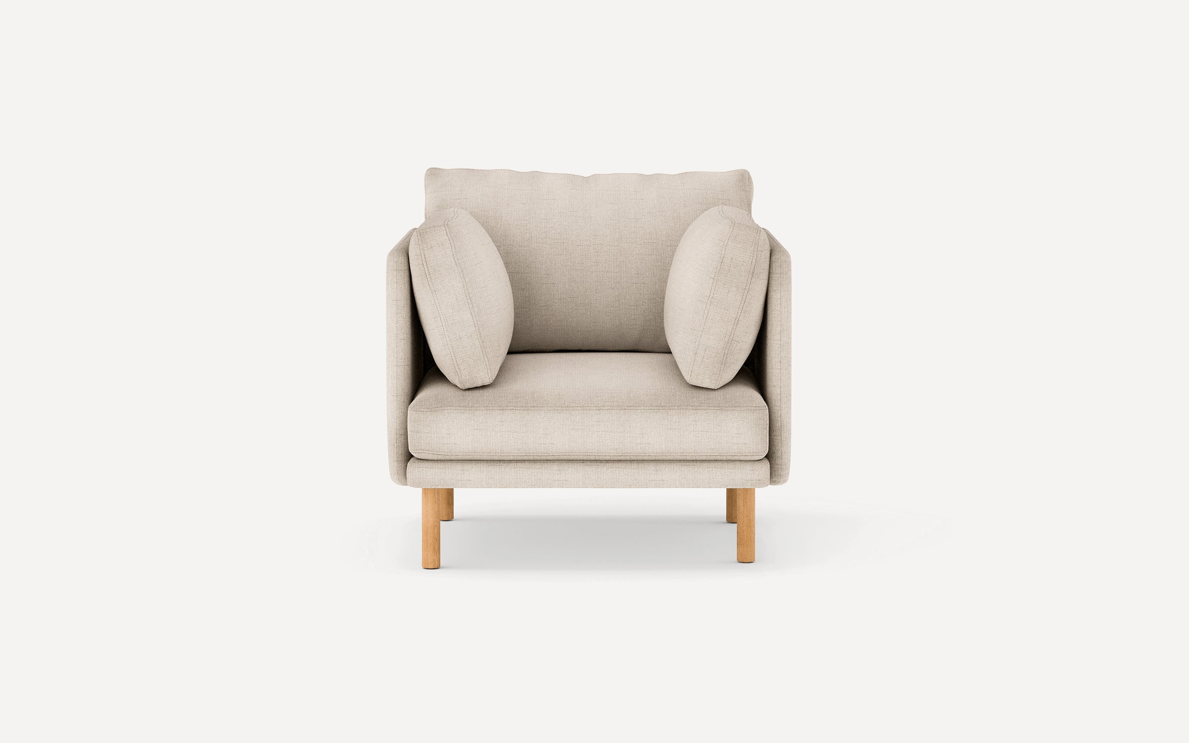Beige fabric armchair with two matching side cushions and wooden legs, shown against a plain white background.