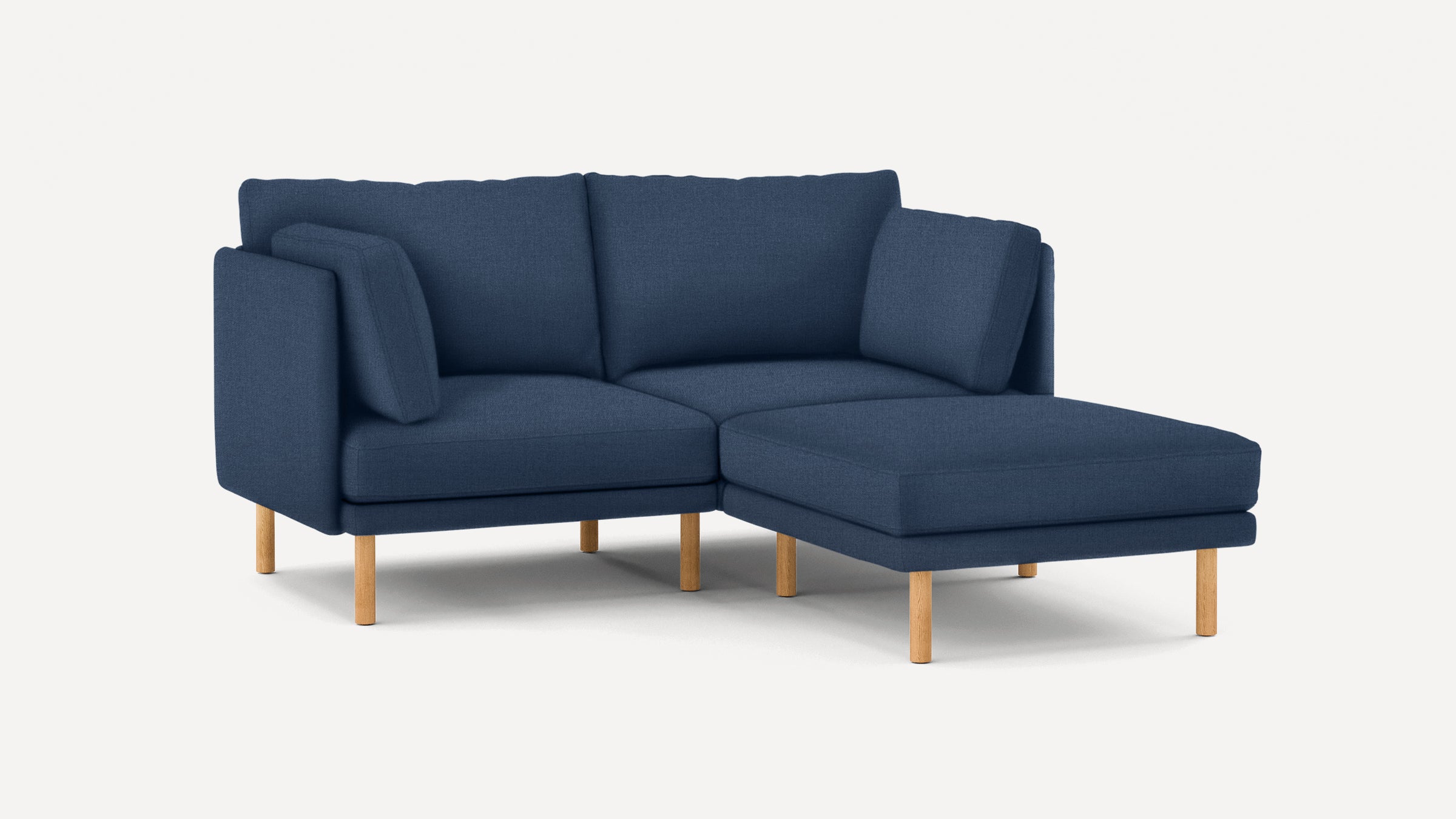 Modern navy blue sectional sofa with wooden legs, clean lines, and plush cushions, ideal for contemporary living spaces.