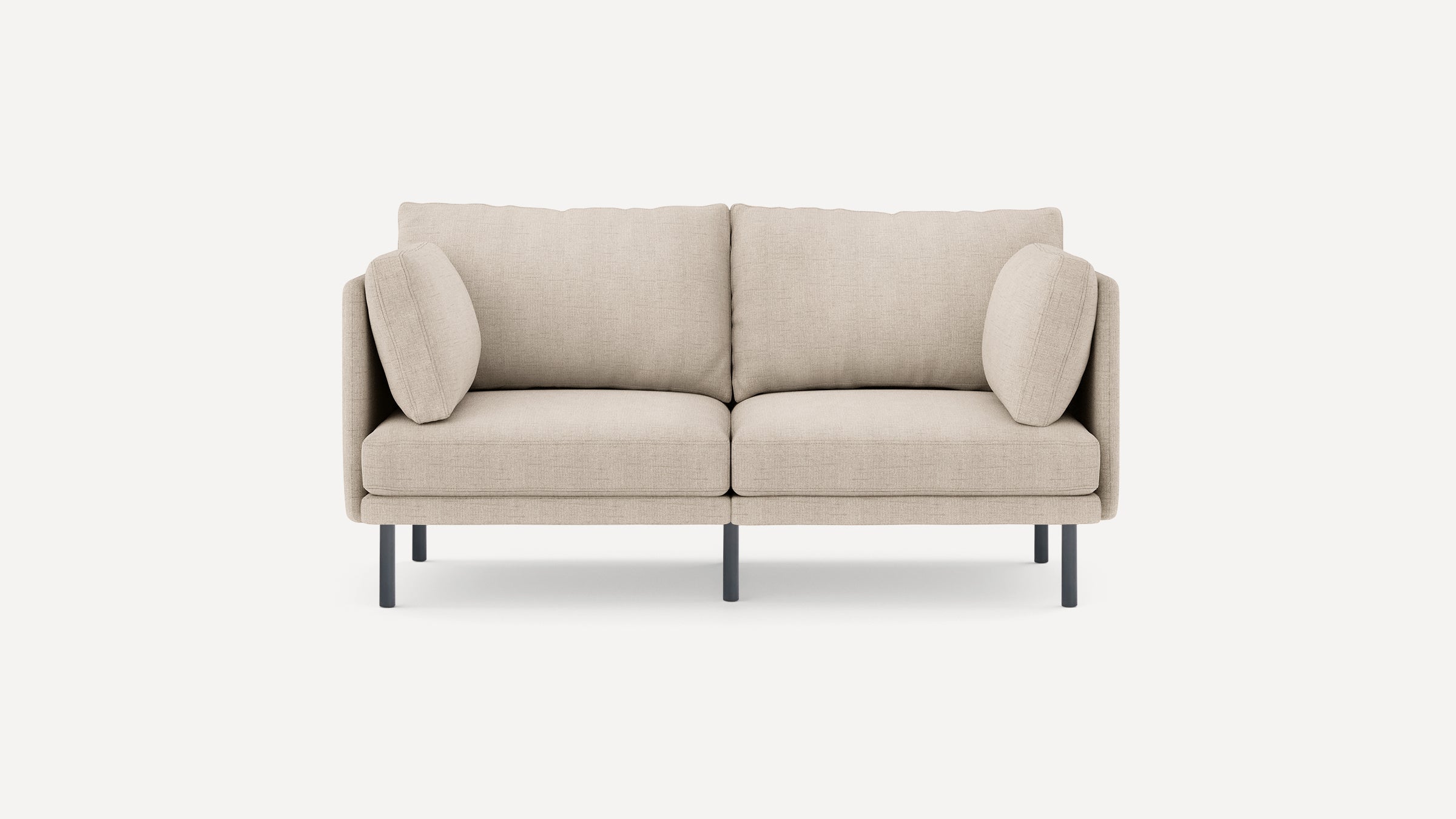 Beige modern two-seater sofa with clean lines, slim black metal legs, and two matching side pillows.