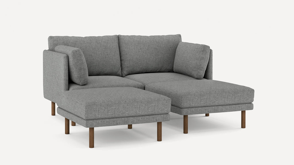 Modern gray fabric sectional sofa with clean lines, wooden legs, and plush cushions, designed for comfort and style.