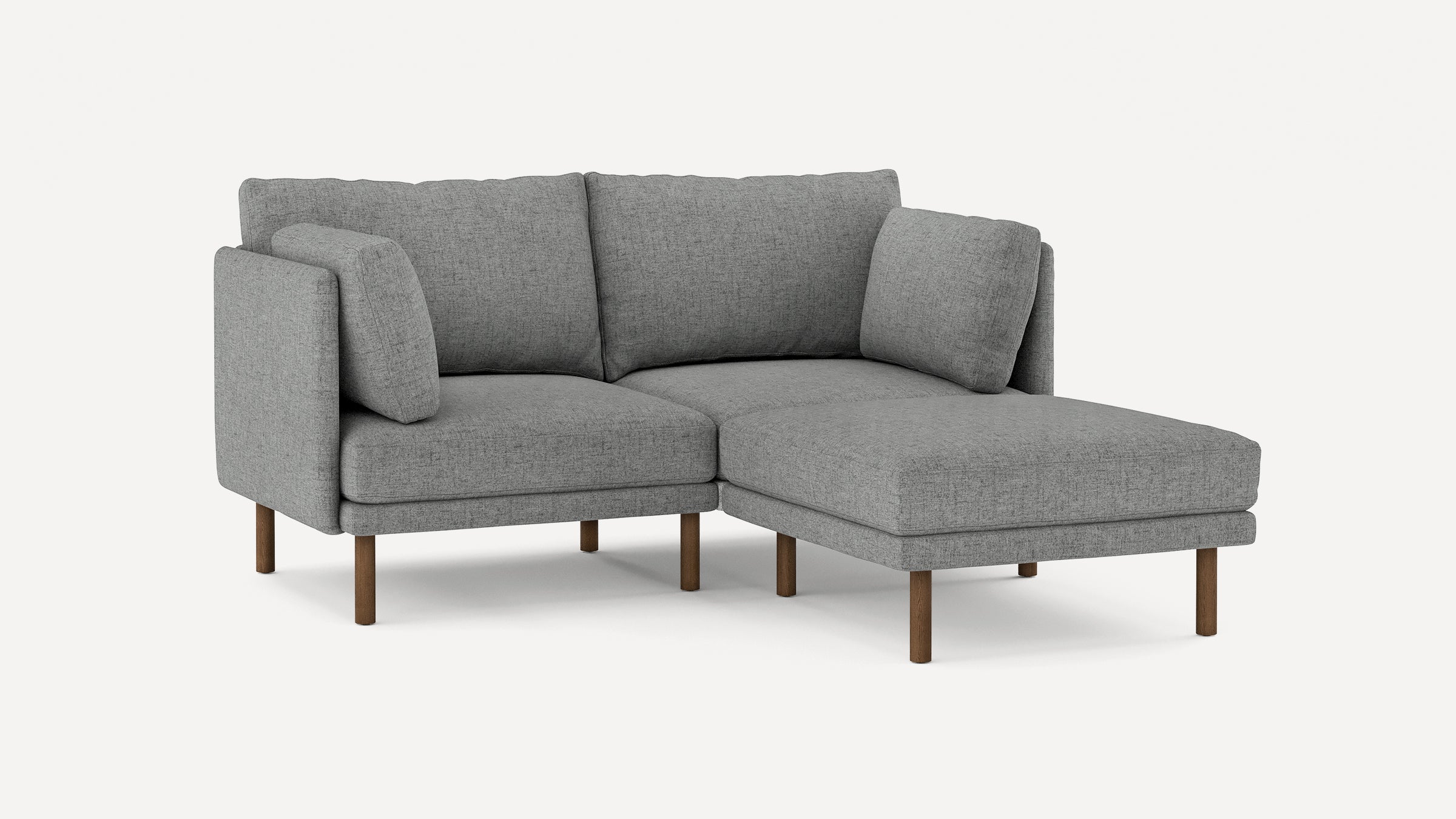 modern gray fabric sectional sofa with wooden legs and clean lines on the back, featuring a chaise lounge, and a matching ottoman