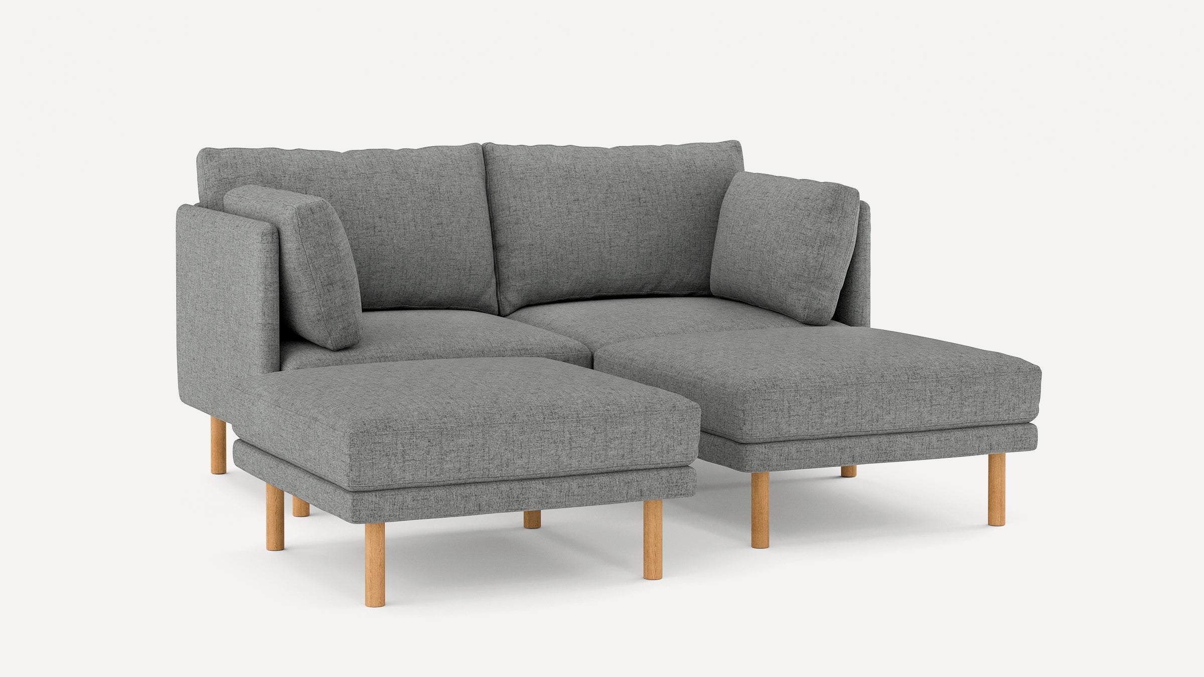 Gray fabric sectional sofa with wooden legs, featuring a chaise lounge and plush back cushions, modern design.