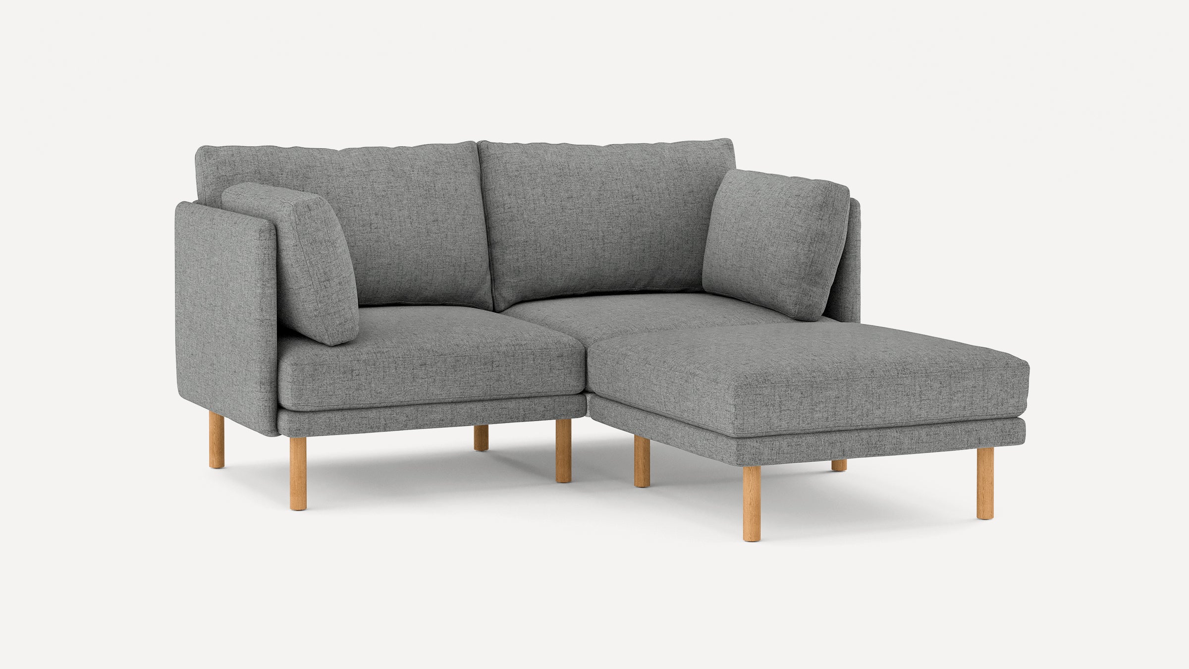 modern gray fabric sectional sofa with wooden legs and clean lines on the back, featuring a chaise lounge, and a matching ottoman