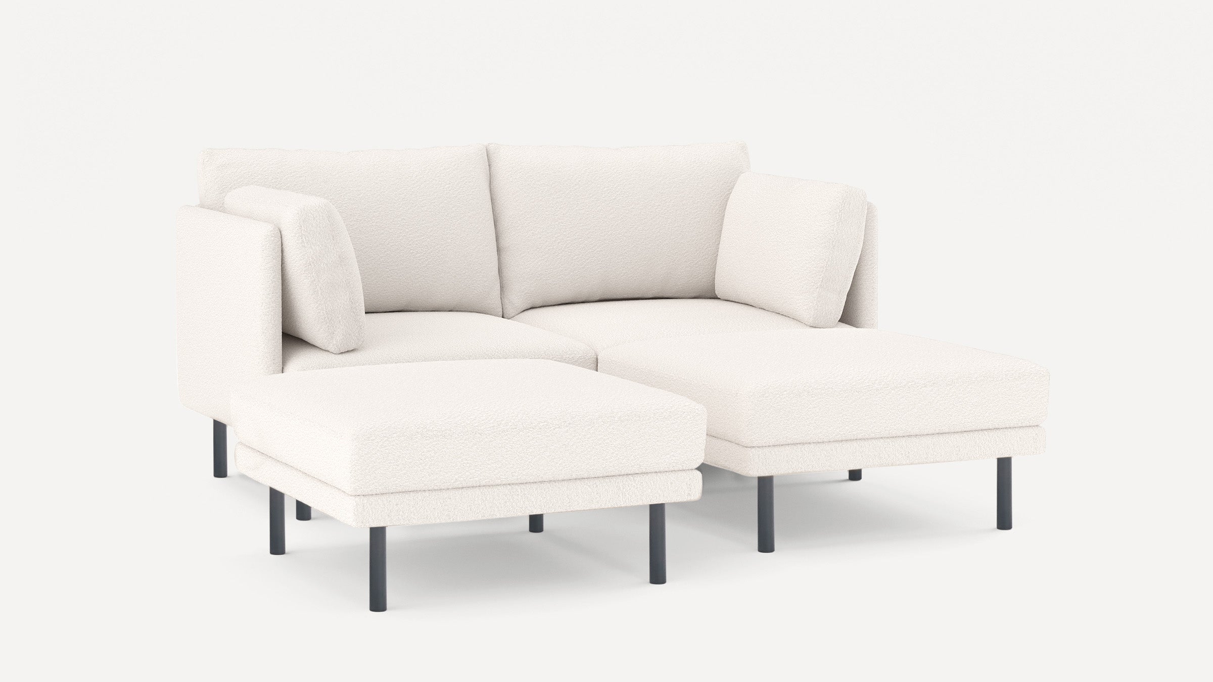 Modern white fabric sectional sofa with two back cushions and metal legs on plain background.