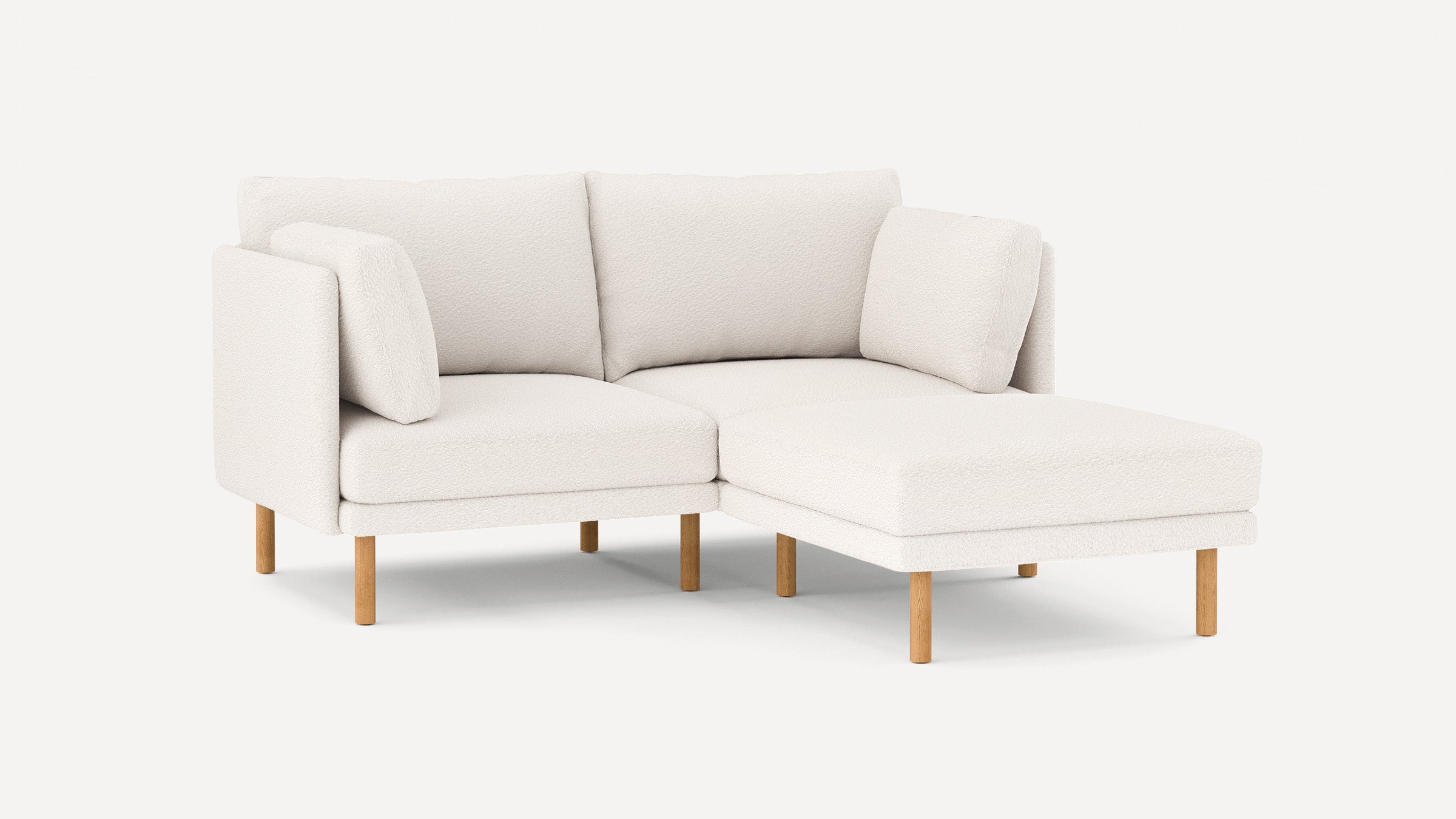 modern l - shaped sectional sofa with light beige upholstery and wooden legs, featuring a clean, minimalist design