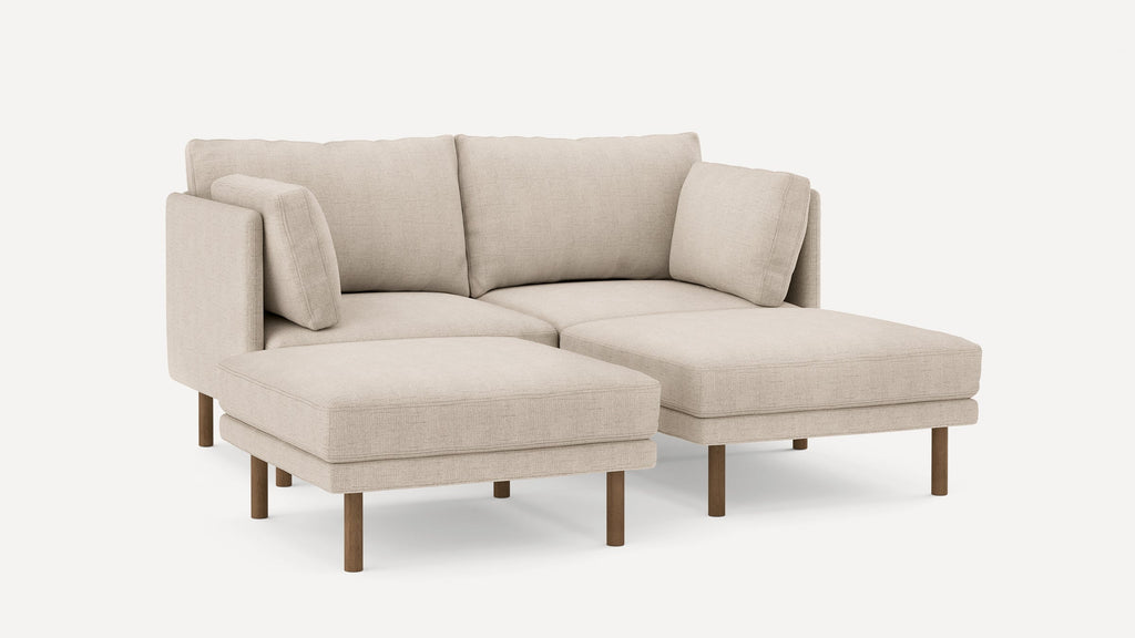 Beige fabric sectional sofa with wooden legs, featuring two large seat cushions and three back cushions against a plain white background.