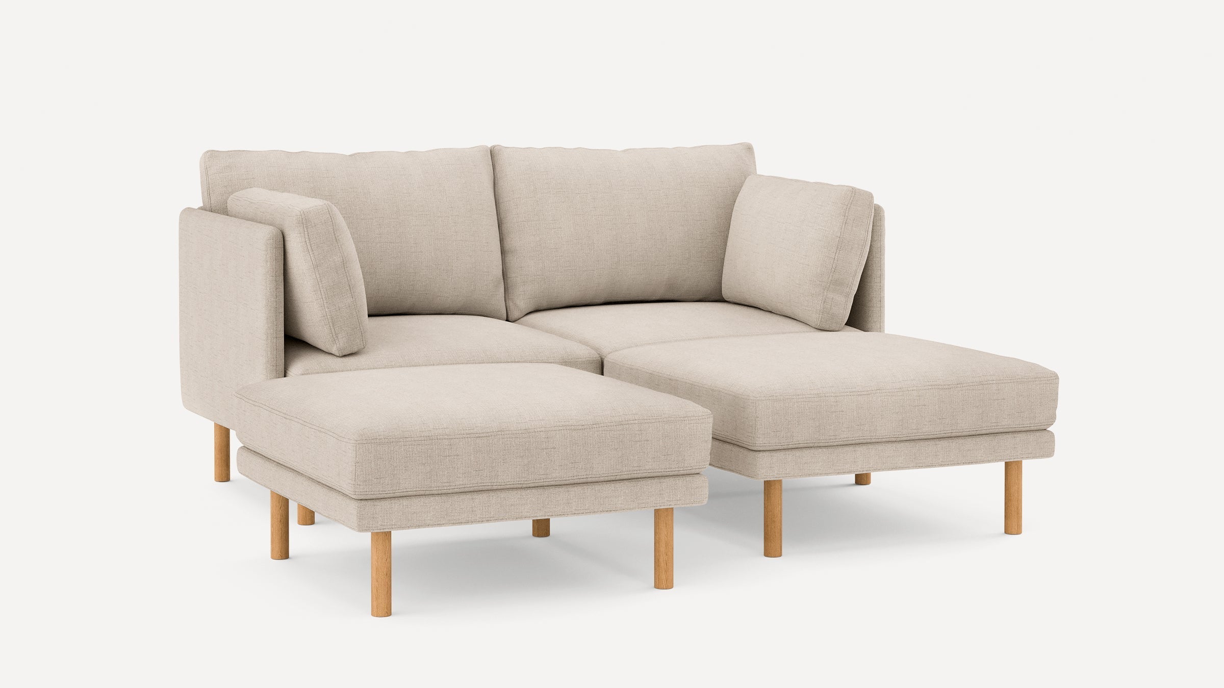 Beige L-shaped sectional sofa with wooden legs, plush cushions, and a modern minimalist design against a plain white background.
