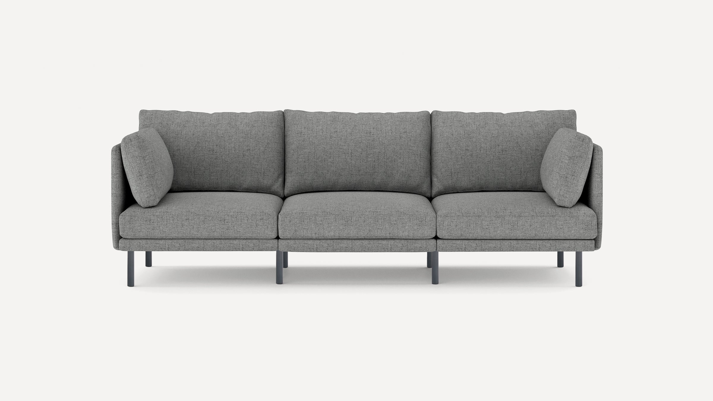 Modern three-seater gray fabric sofa with thin black legs and matching side cushions on a plain white background.