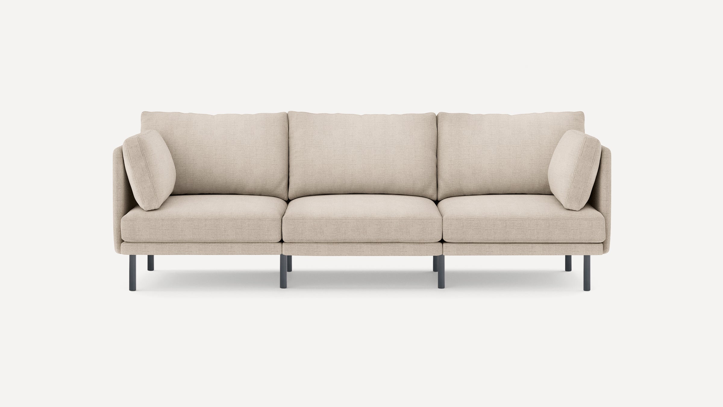 Beige modern three-seater sofa with fabric upholstery, slim armrests, removable cushions, and black metal legs on a white background.