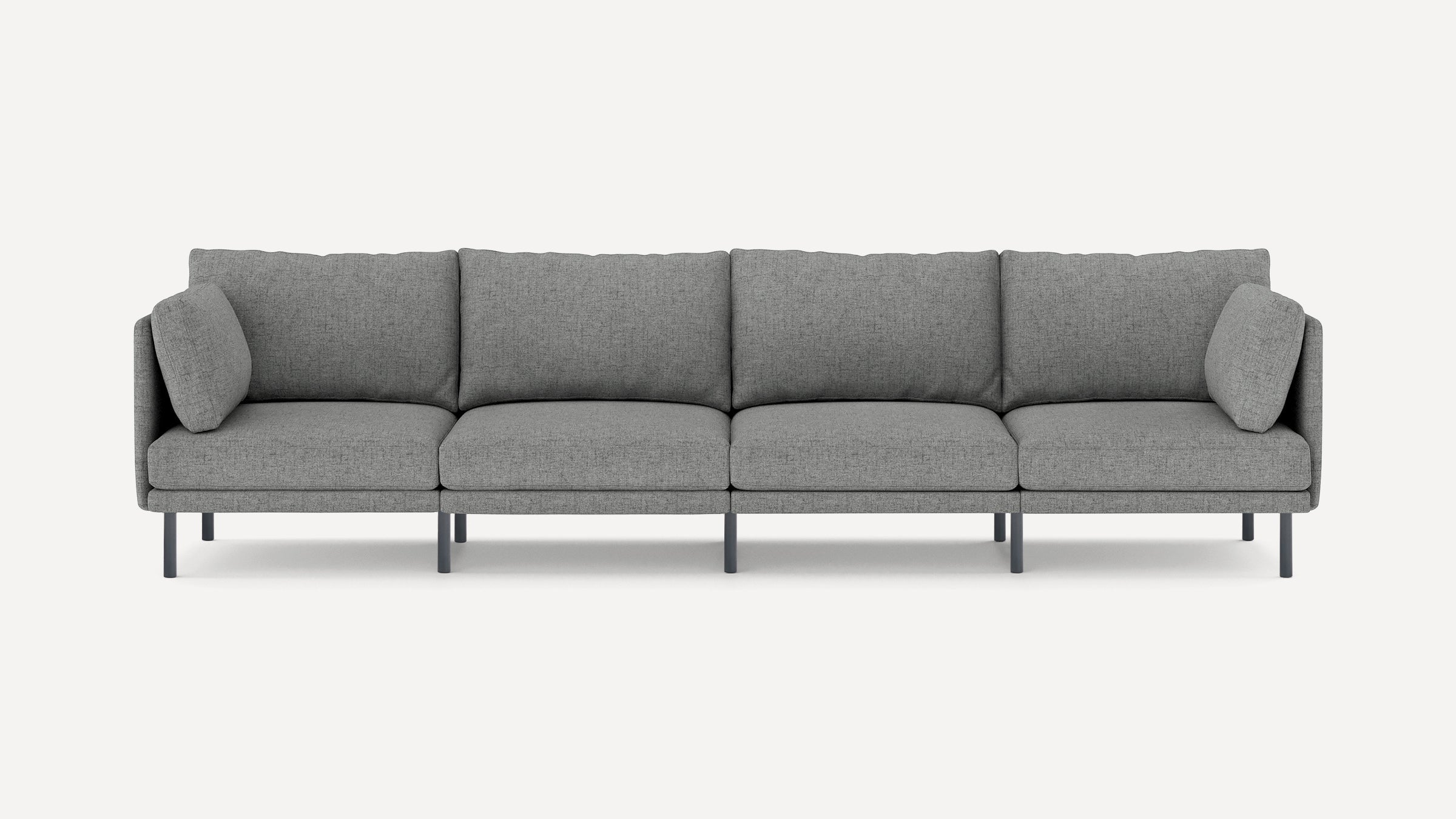 Modern grey fabric four-seater sofa with slim black legs and matching side cushions, set against a plain white background.