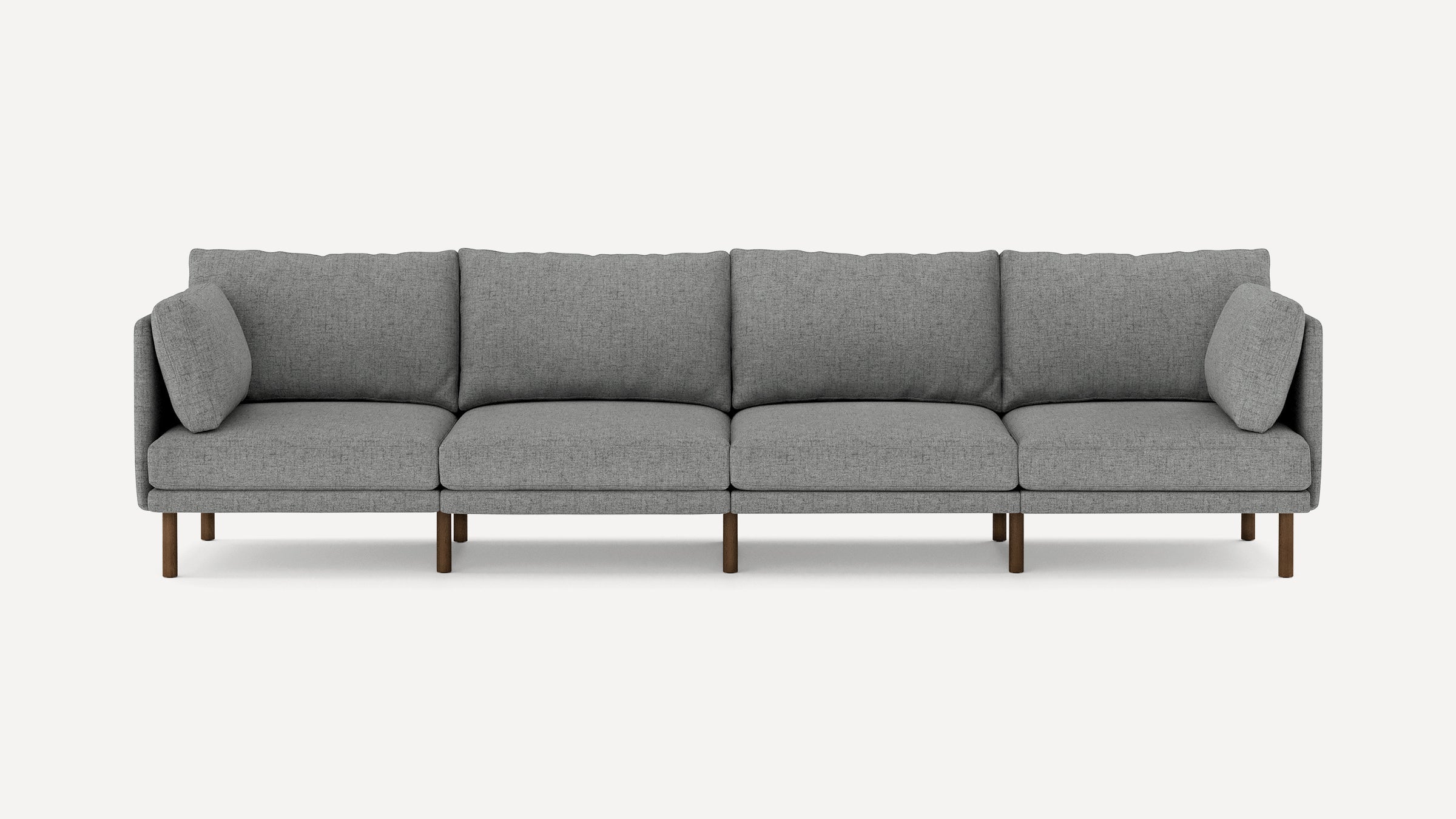 Modern gray fabric four-seater sofa with wooden legs and cushioned armrests, shown against a plain white background.