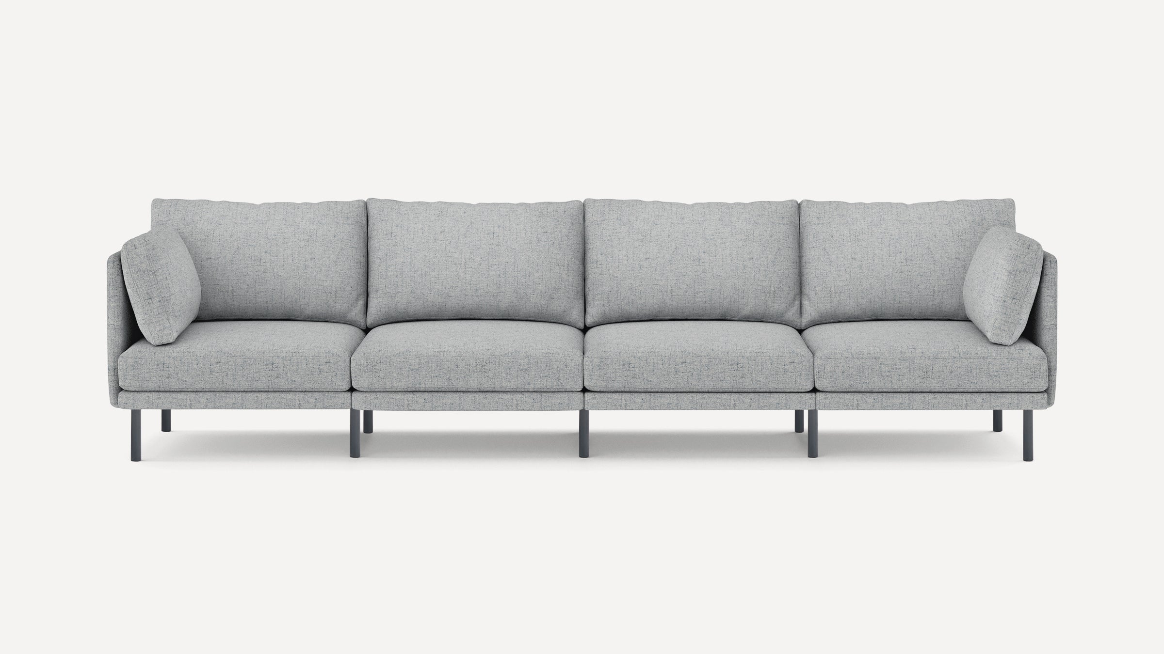 Modern light gray fabric four-seater sofa with slim black legs and plush back and side cushions, minimalist design.
