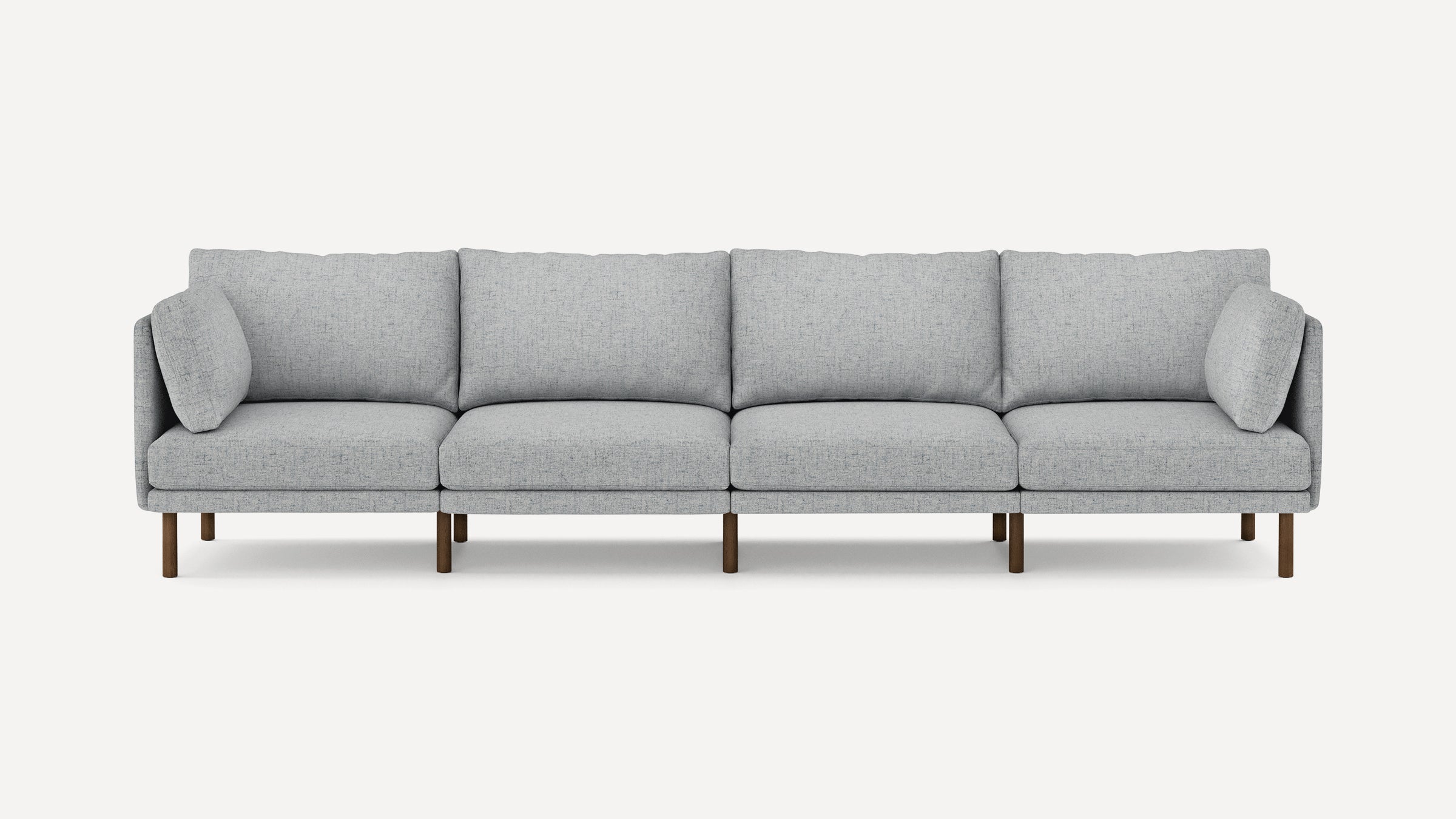 Modern light gray fabric sofa with clean lines, four seat cushions, two side pillows, and wooden legs against a white background.