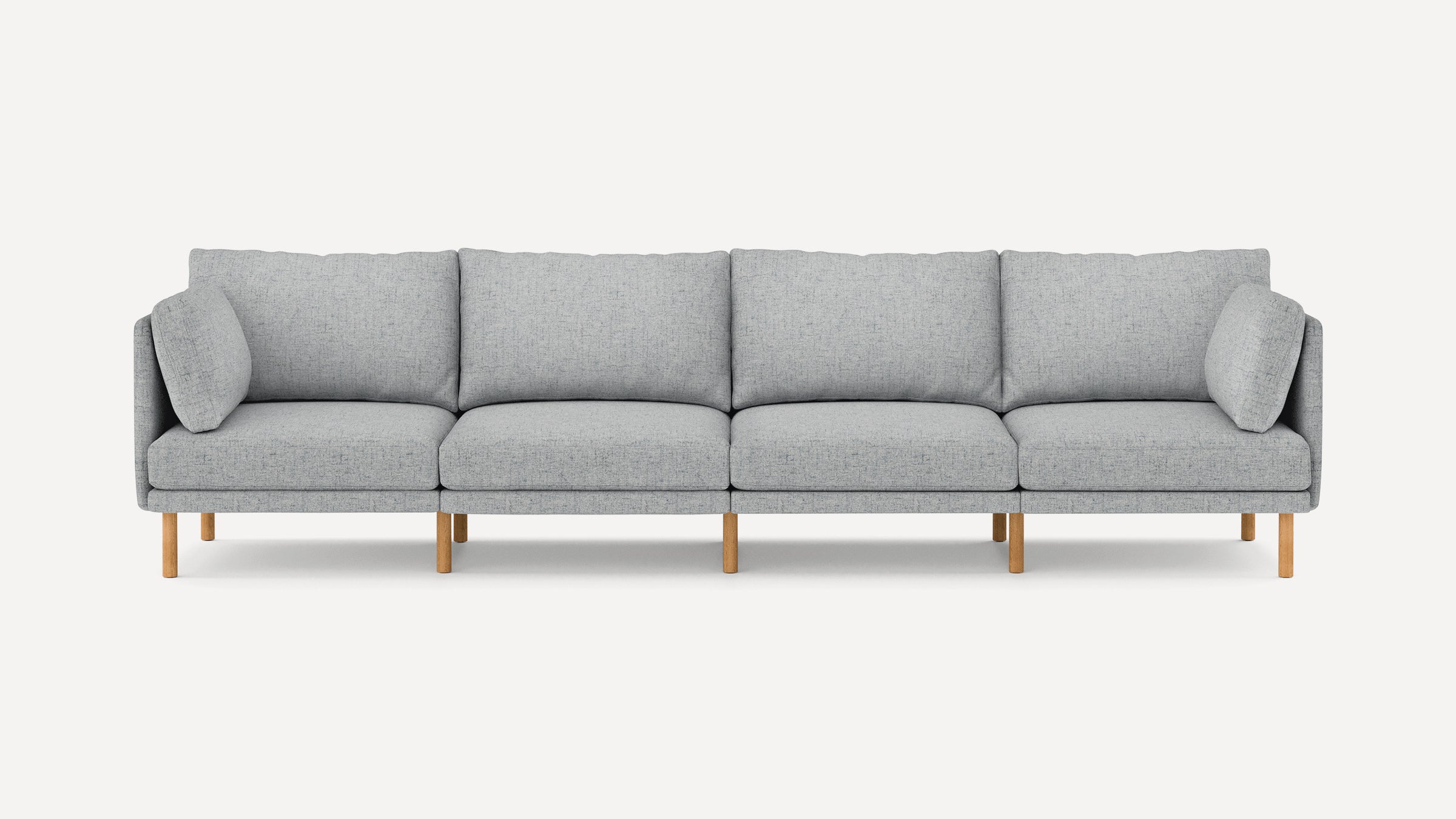 Modern light gray fabric sofa with wooden legs, featuring four seat cushions and two side pillows.