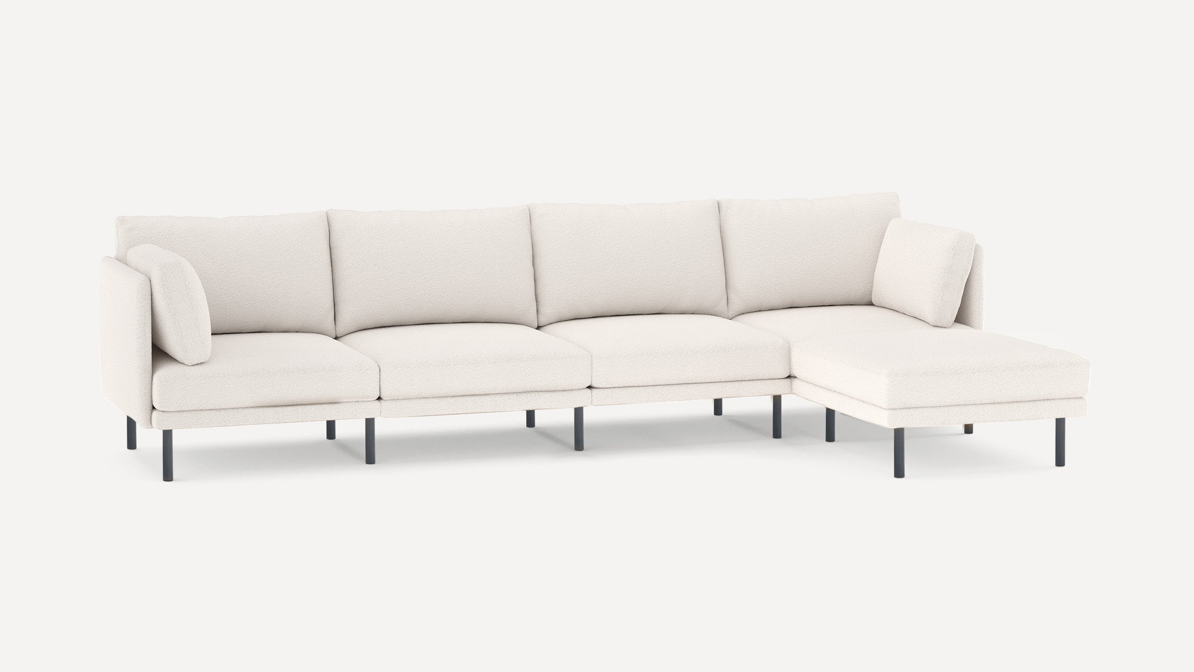Modern white sectional sofa with textured fabric, clean lines, metal legs, and included cushions for added comfort.
