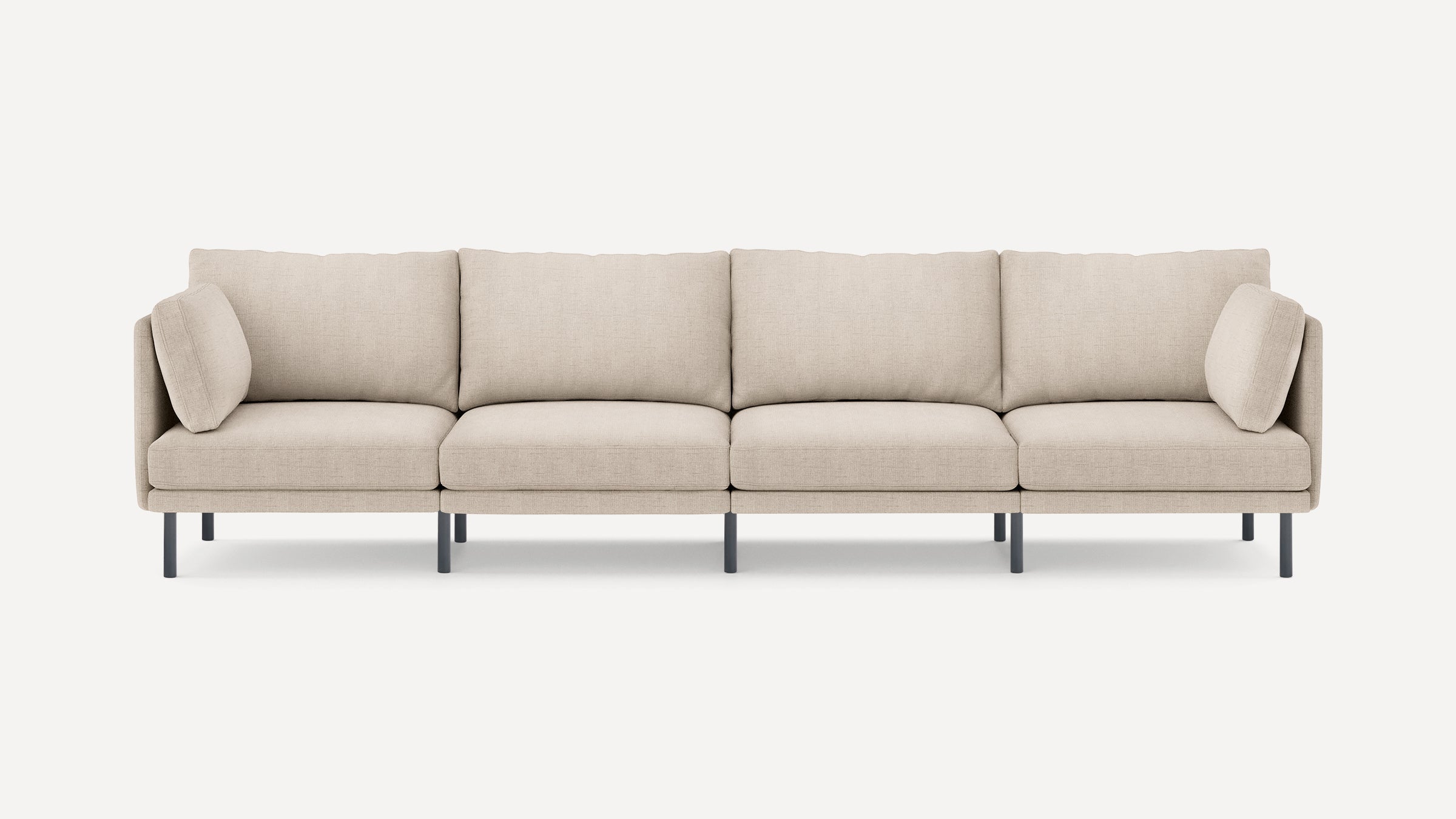 Four-seater modern beige fabric sofa with clean lines, slim black legs, and removable cushions, set against a white background.